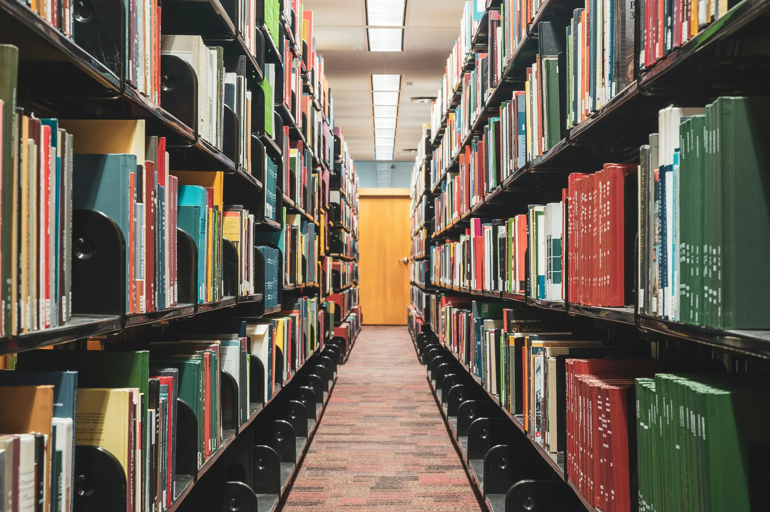 Library isle full of books on the right and left side.