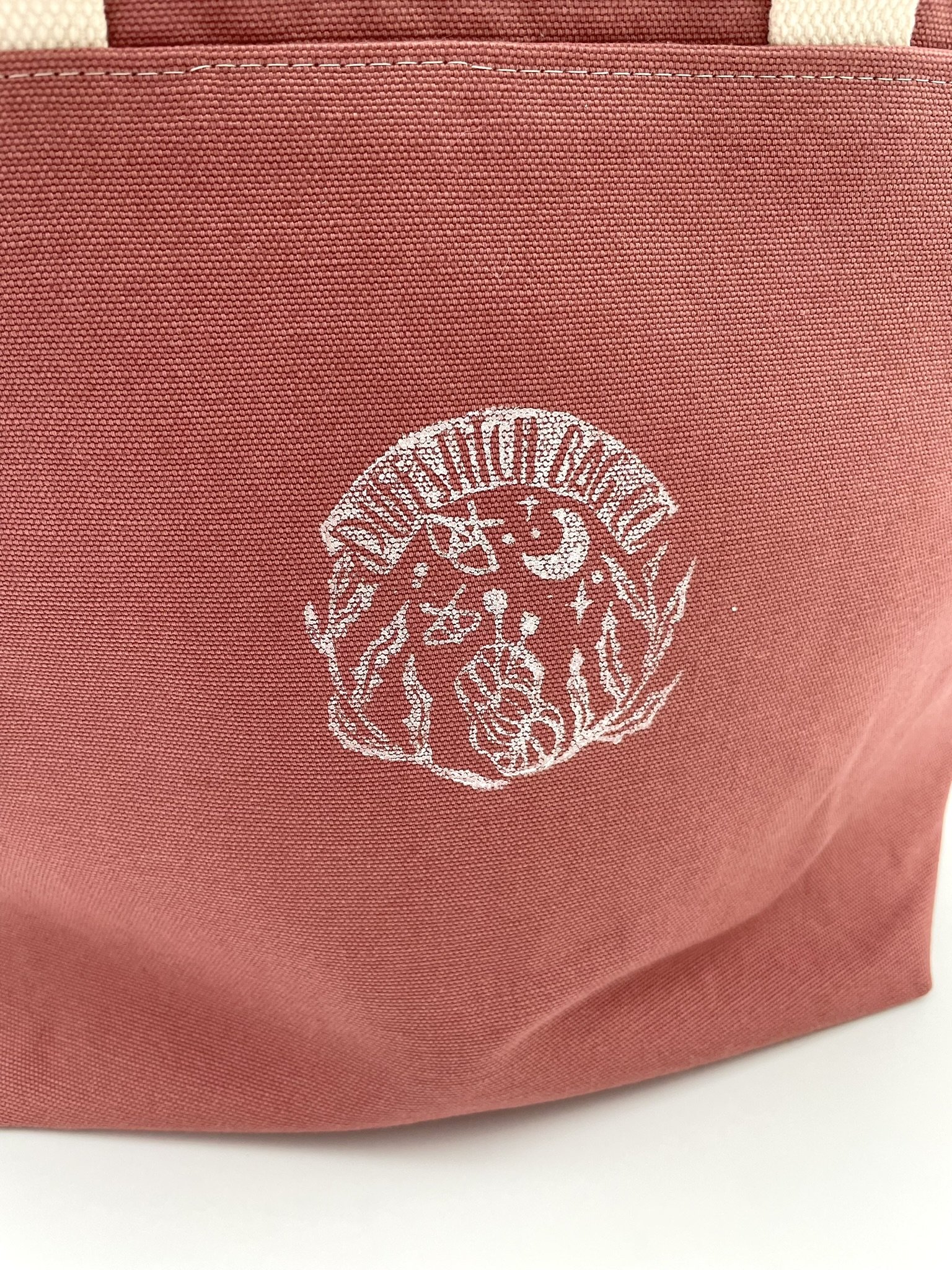 Close-up of Puff Stitch logo on large pink project bag