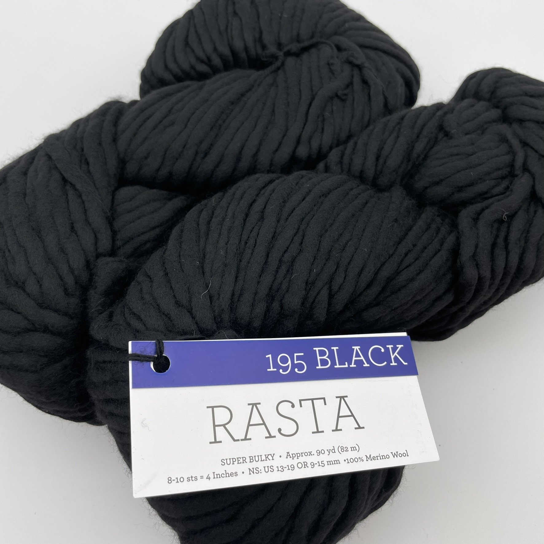 Close-up of Malabrigo Rasta yarn in Black colorway, a rich and deep black super bulky merino wool skein.