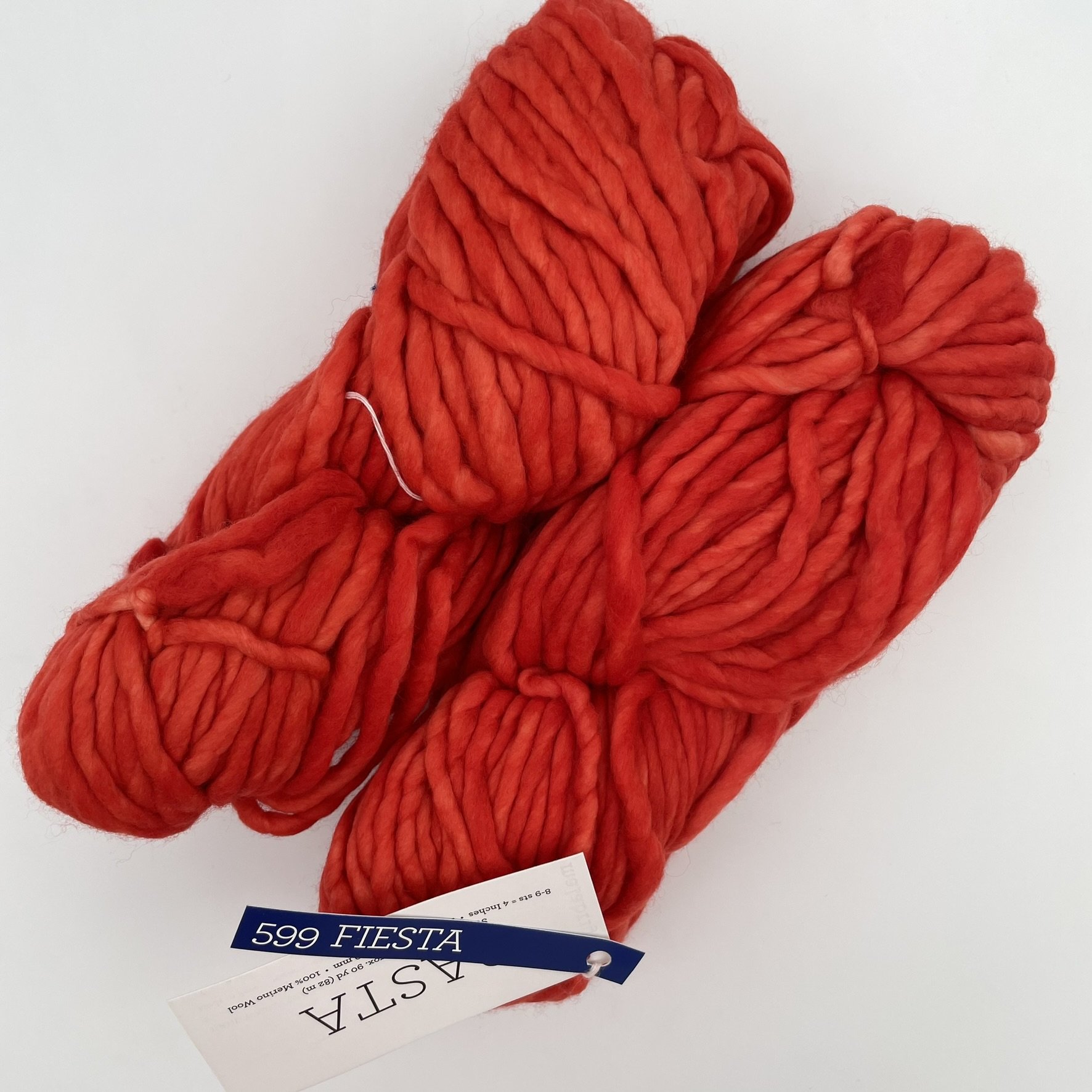 Malabrigo Rasta yarn in Fiesta colorway, a bold red-orange super bulky merino wool skein for knitting or crochet projects.
