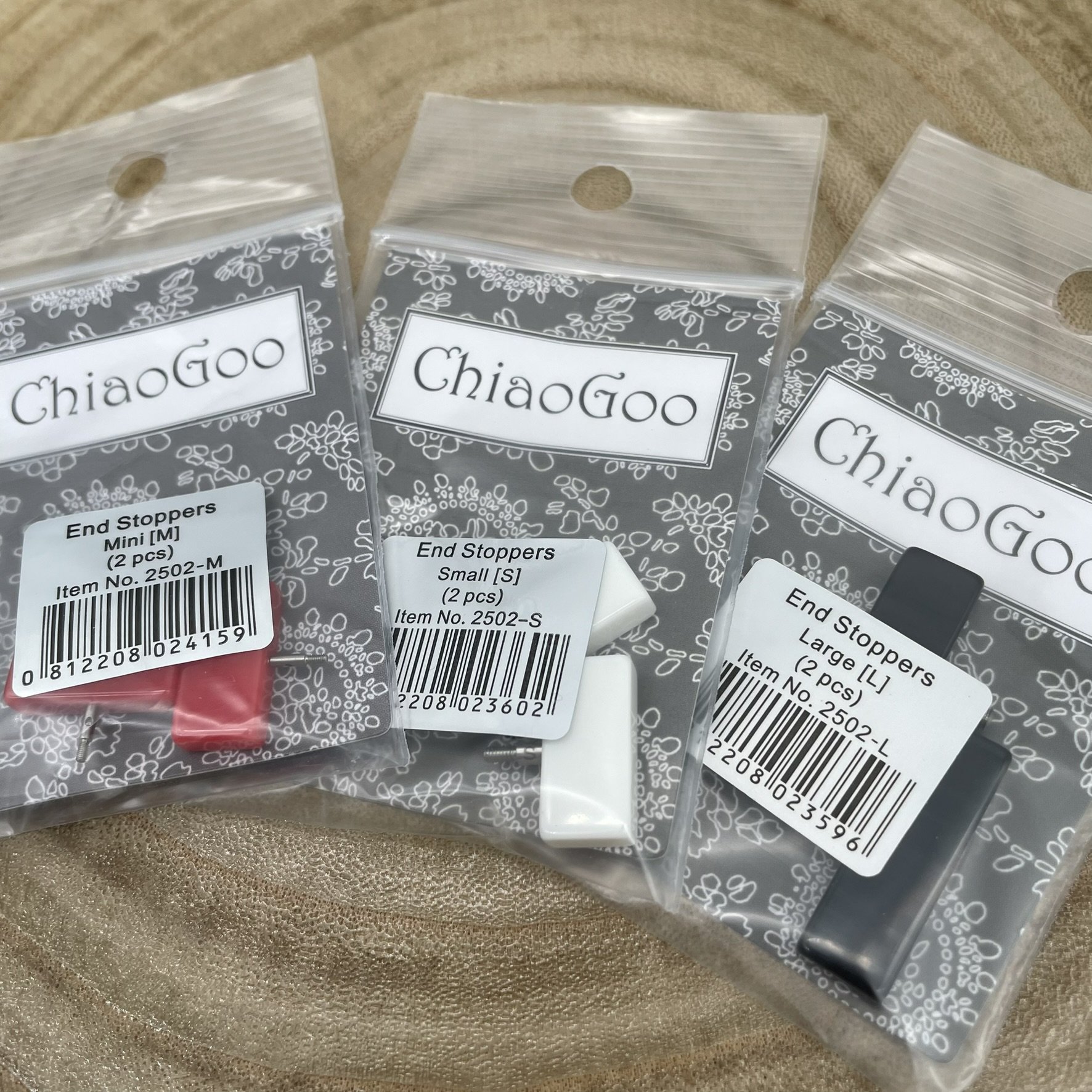 ChiaoGoo end stoppers in mini, small, and large sizes for securing interchangeable knitting cables.