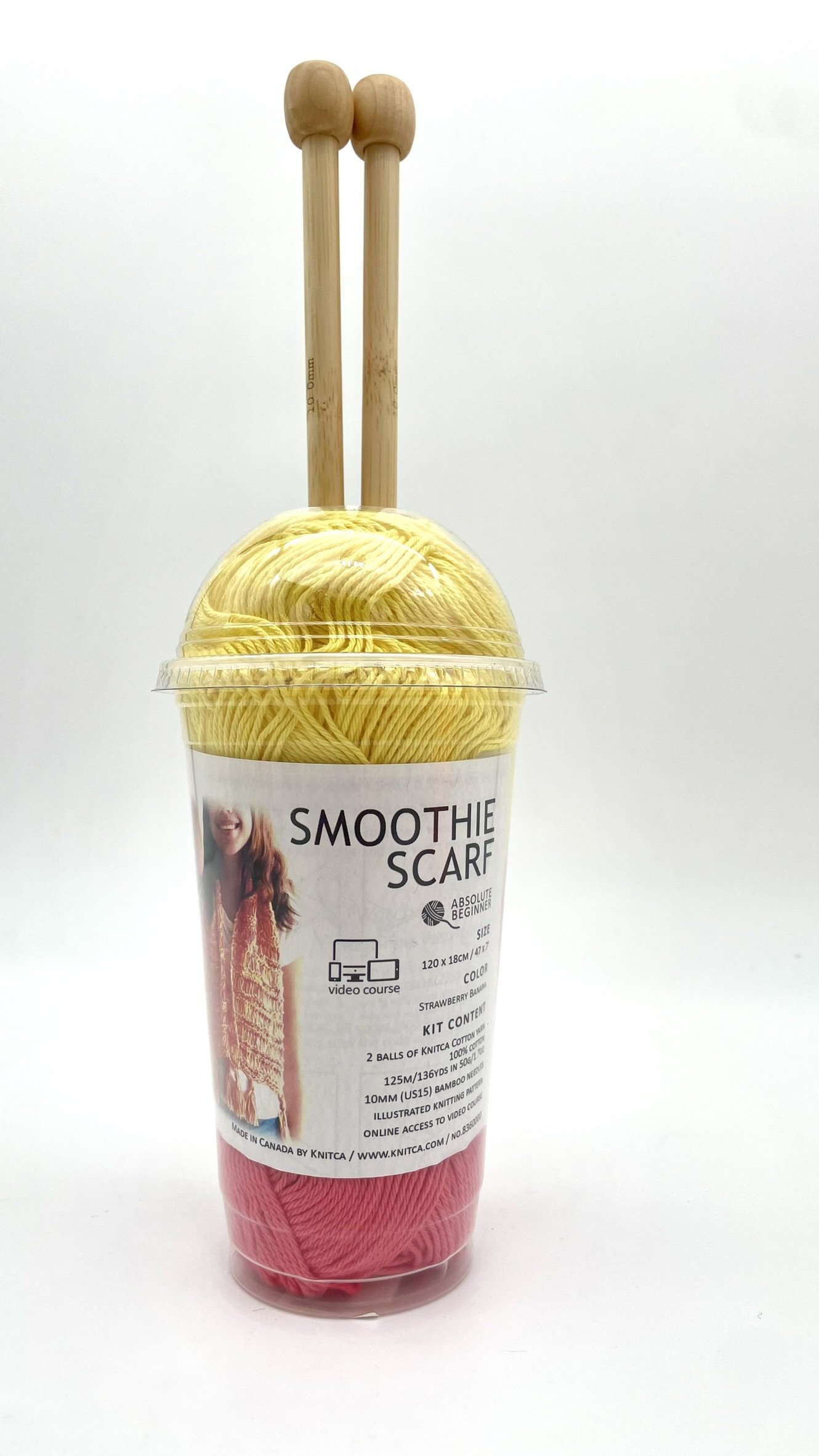 DIY Smoothie Scarf kit in yellow and pink with bamboo knitting needles front view.