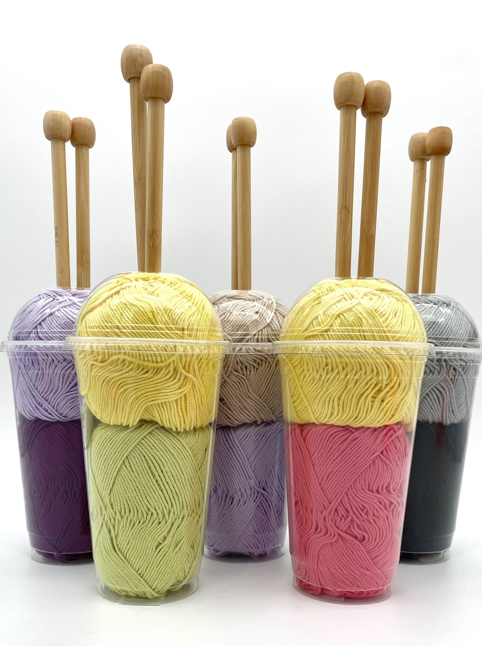 DIY Smoothie Scarf Knitting Kit by Knitca featuring colorful yarn cups with wooden knitting needles, ideal for beginners.