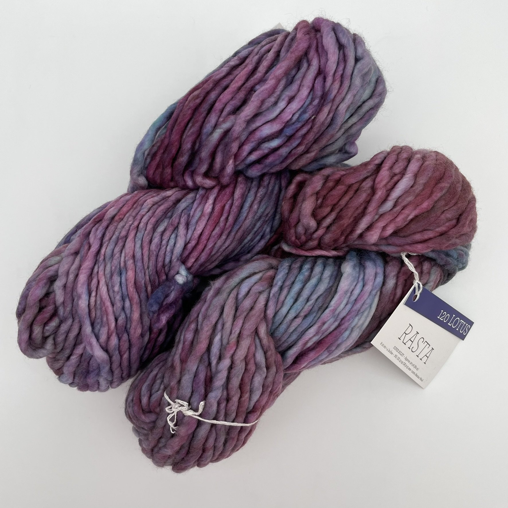 Malabrigo Rasta yarn in Lotus colorway, featuring soft purples and pinks in super bulky merino wool skeins.