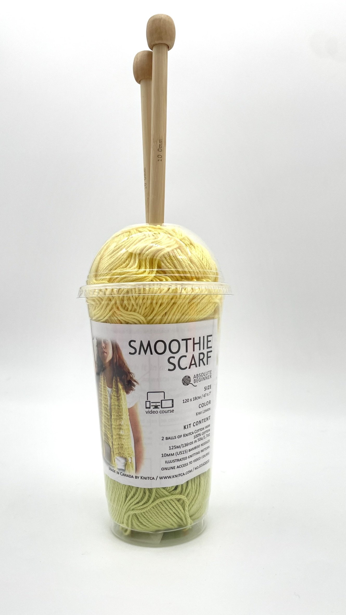 DIY Smoothie Scarf kit in yellow and green with bamboo knitting needles front view.