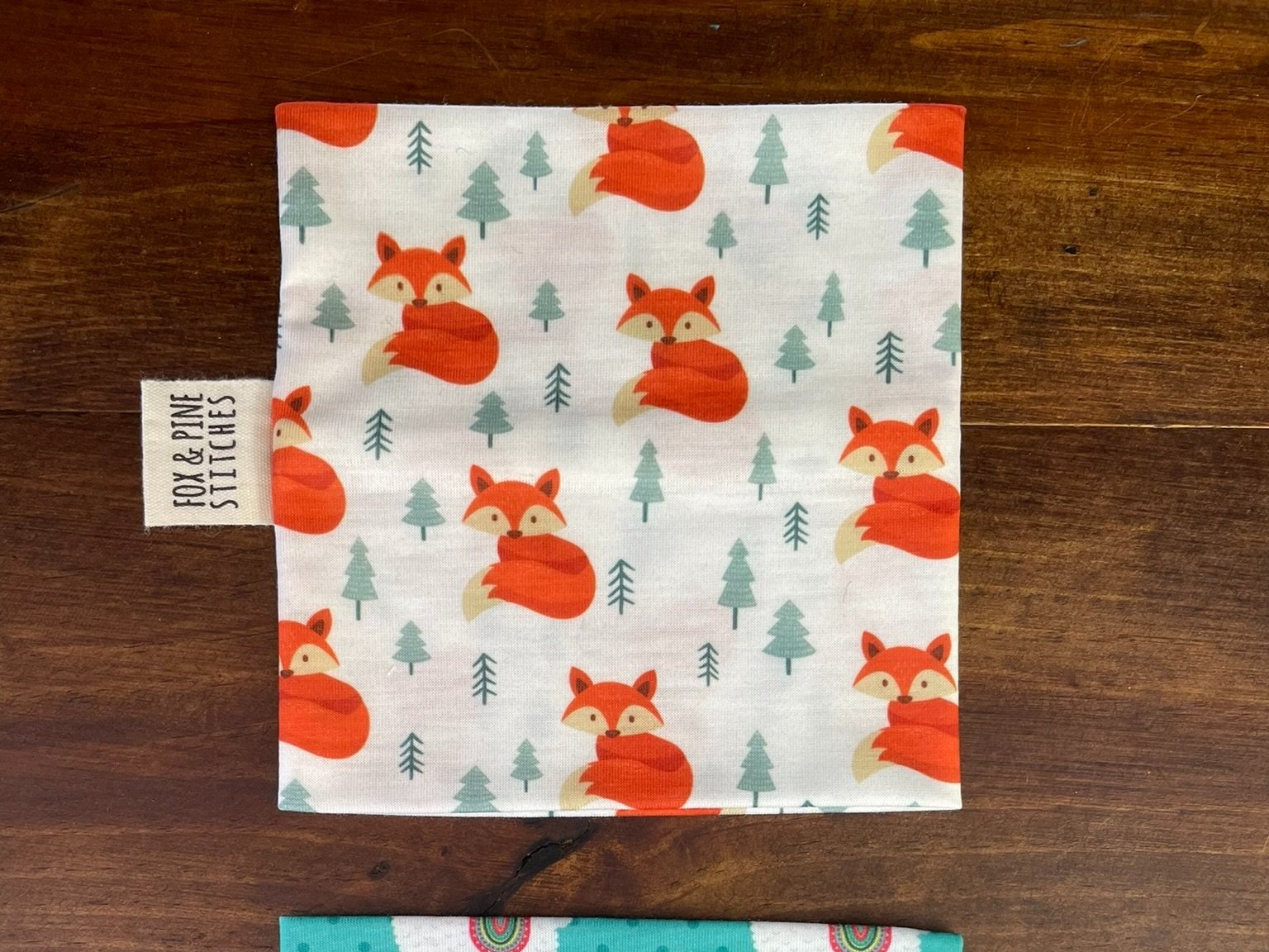 Fox & Pine yarn sweater featuring a playful fox print with small trees on a white background.