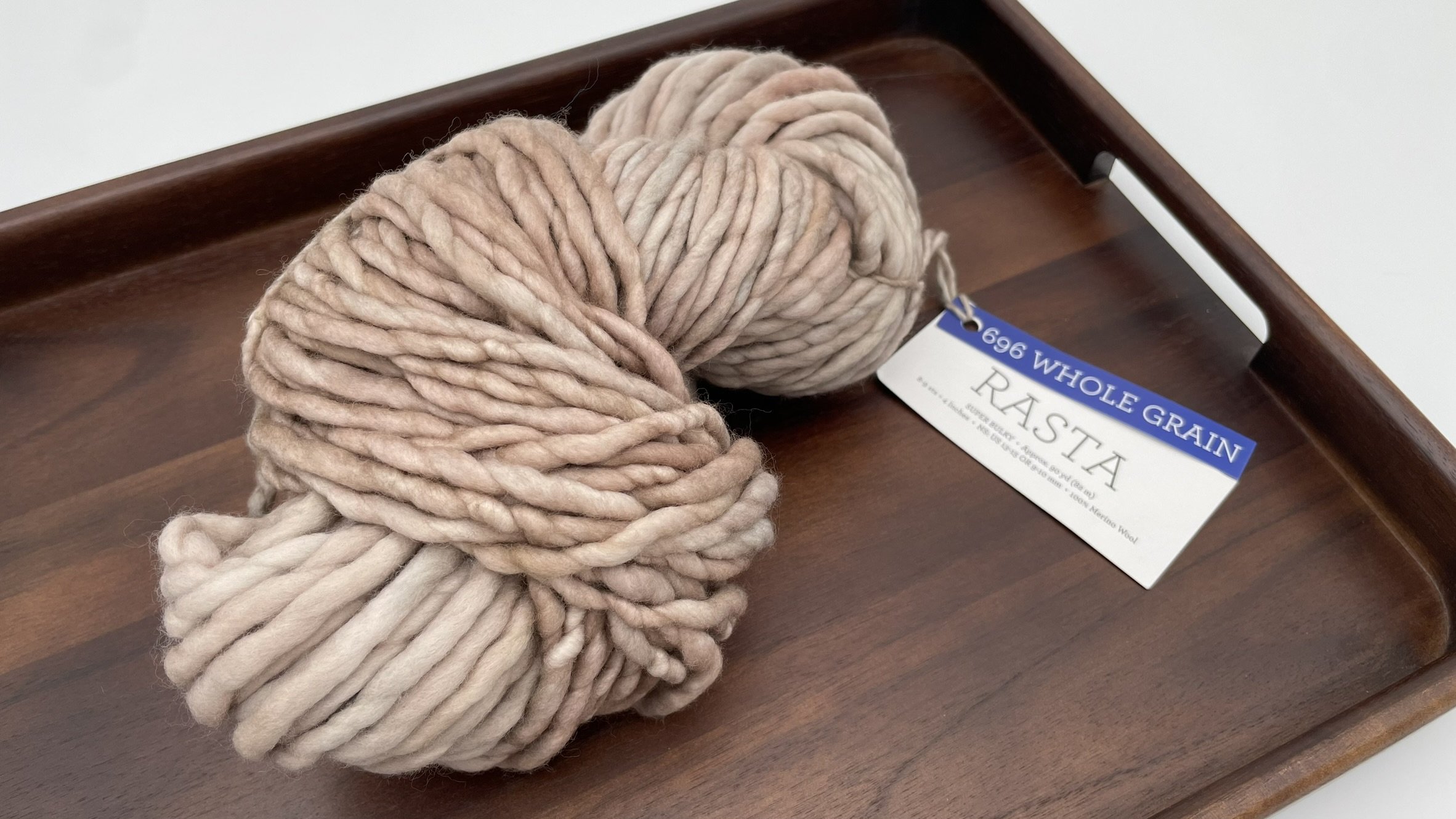 Skein of Malabrigo Rasta yarn in Whole Grain color, super bulky texture in soft beige tones, 100% Merino wool.