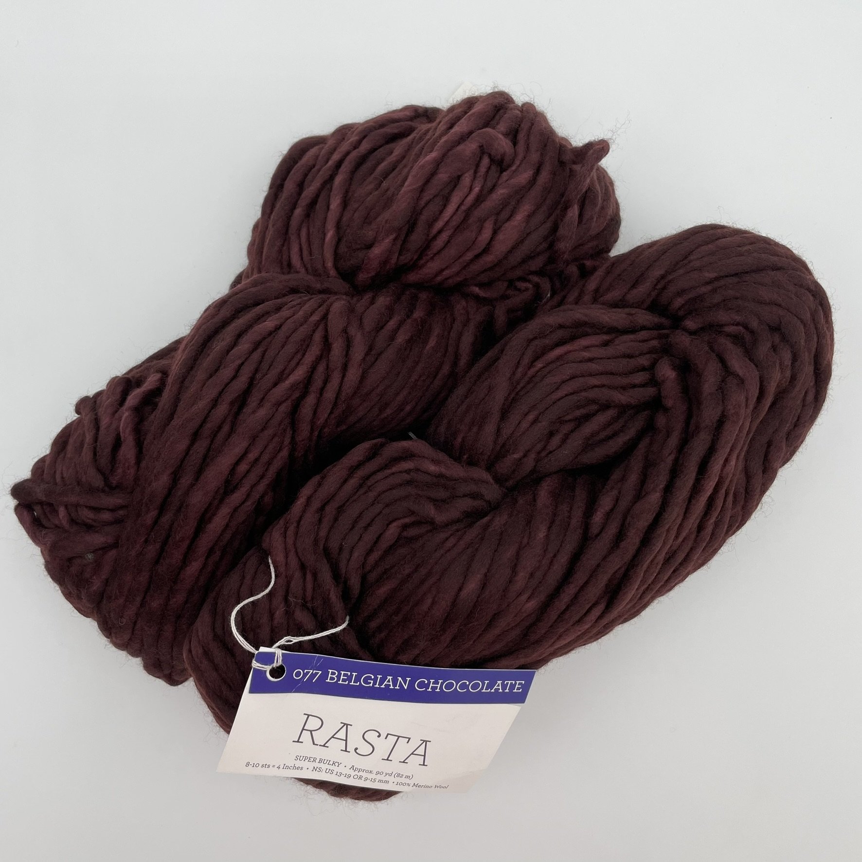 Close-up of Malabrigo Rasta yarn in Baya Electrica colorway, showcasing vibrant purple and pink shades in super bulky merino wool.
