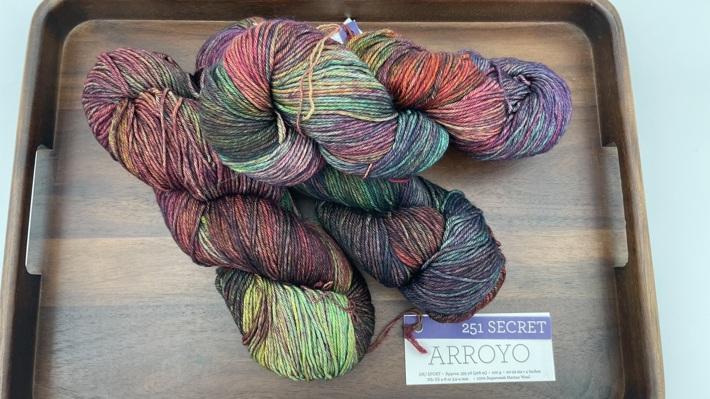 Top view of Malabrigo Arroyo Secret color yarn in DK/Sport weight, artfully arranged on a tray.