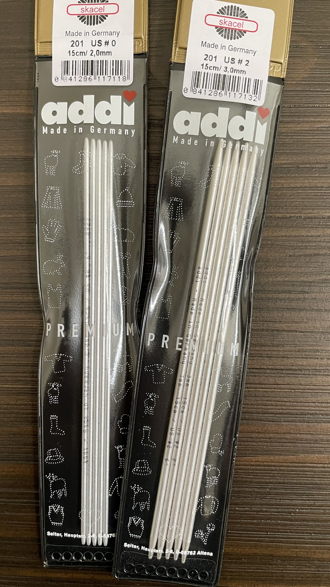 Multiple packages of Addi 6-inch aluminum double-pointed needles.