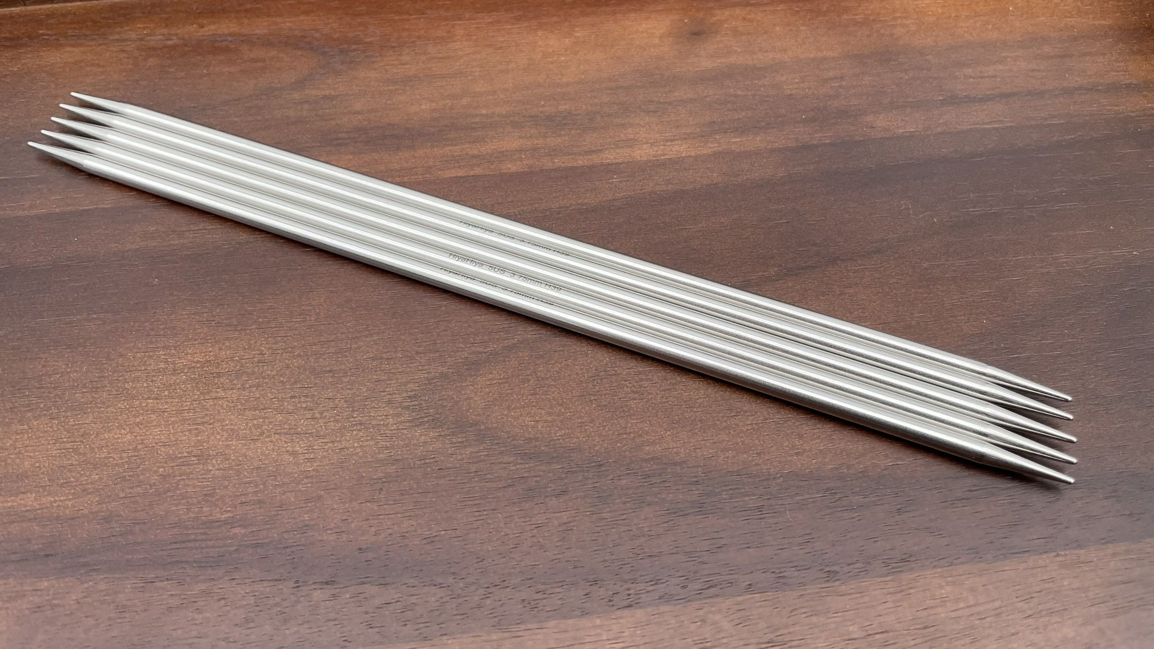 HiyaHiya 8-inch steel double-pointed knitting needles in packaging with yarn in the background