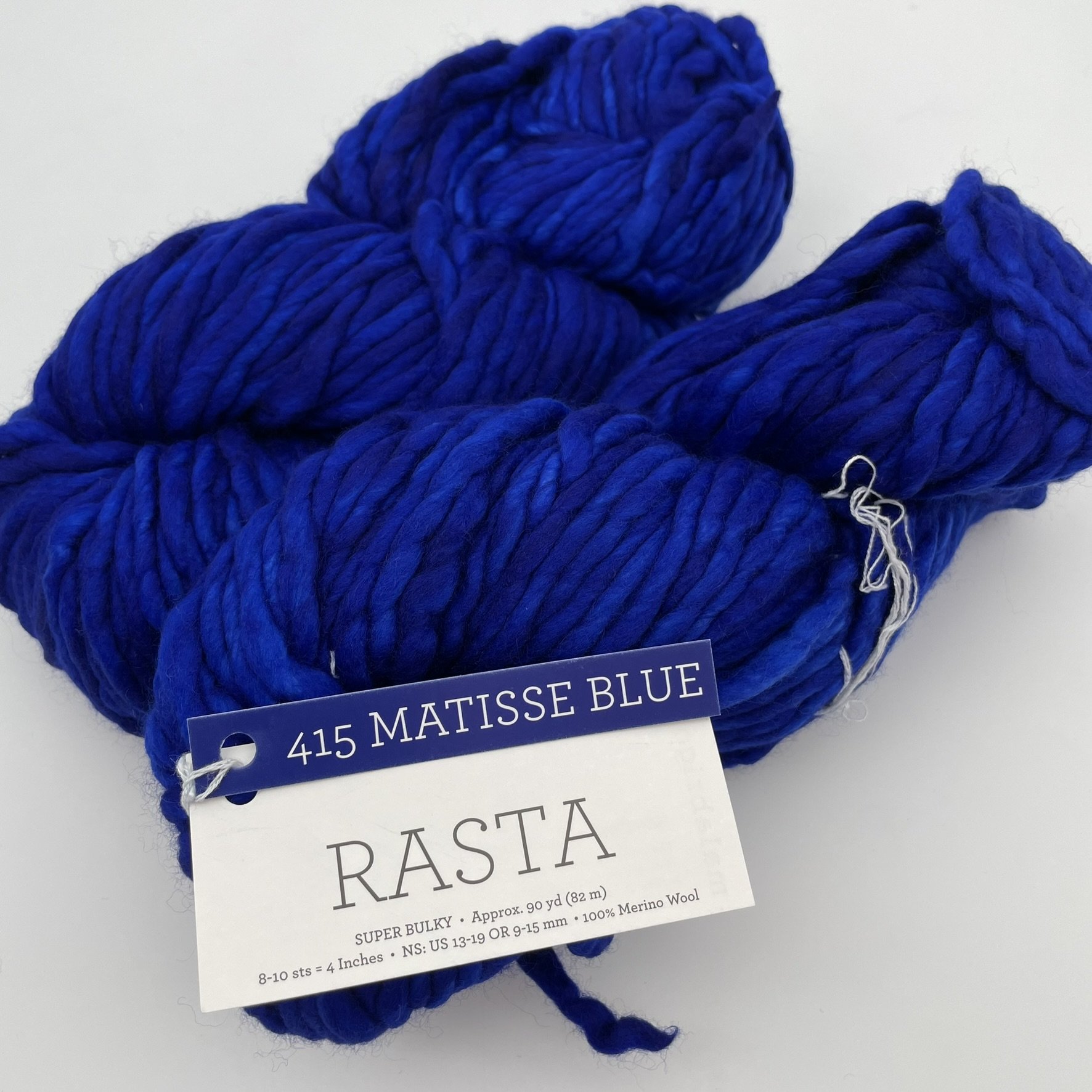 Close-up of Malabrigo Rasta yarn in Matisse Blue colorway, showcasing intense deep blue shades in super bulky merino wool.