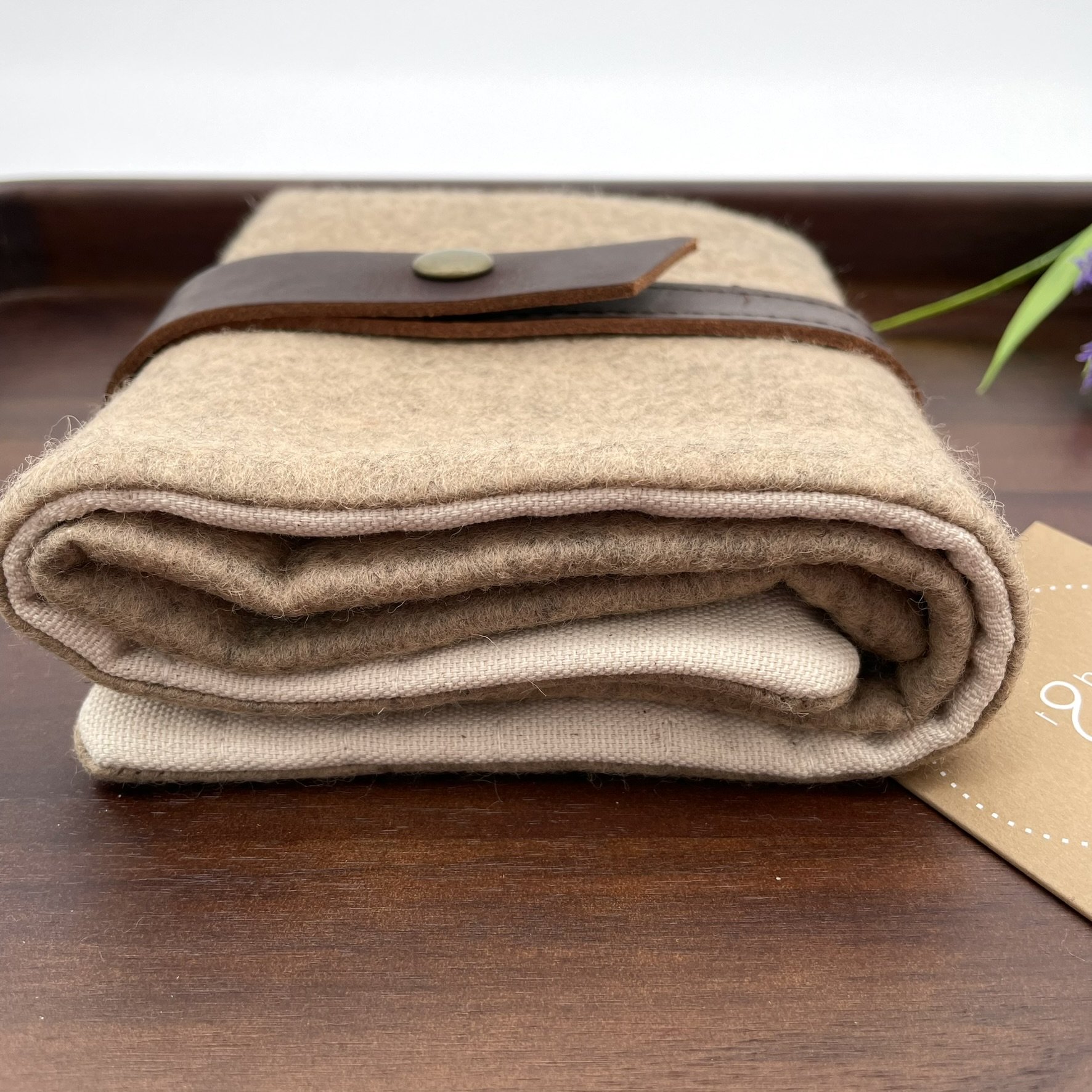 Bottom view of the Twig & Horn natural wool knitting tool pouch, showcasing its smooth wool texture and durable construction.
