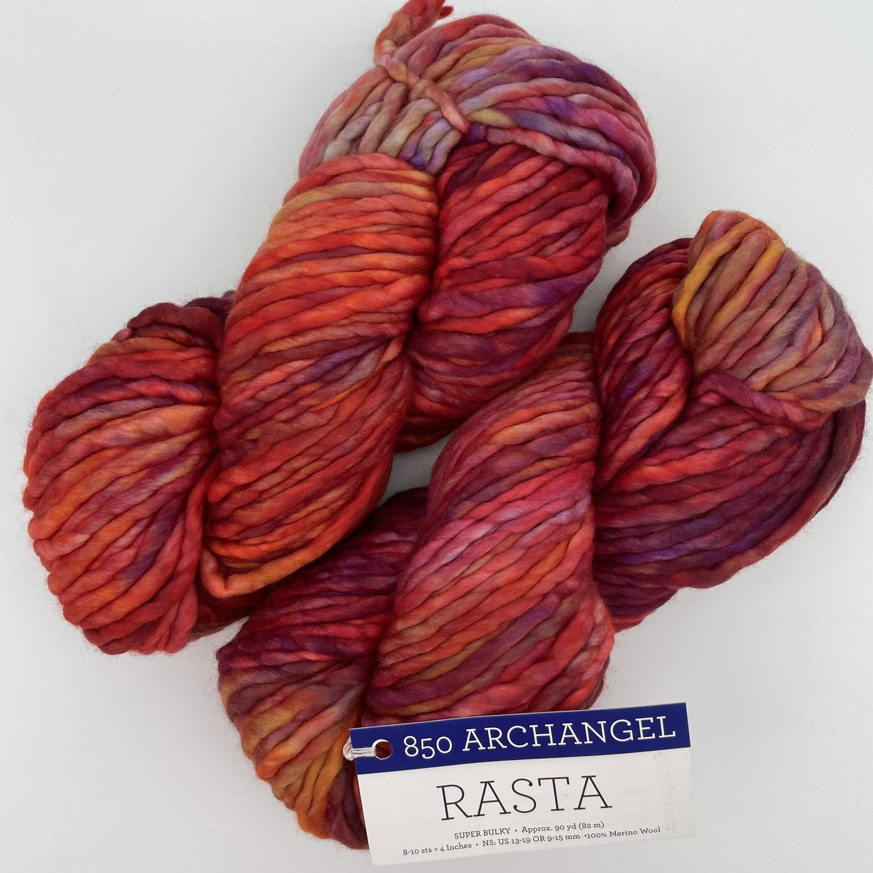 Malabrigo Rasta yarn in Archangel colorway, featuring a blend of deep reds, oranges, and purples in super bulky merino wool.