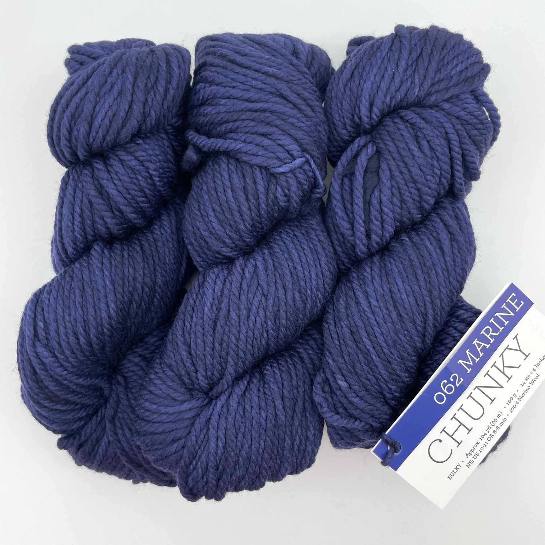 Malabrigo Chunky yarn in Marine colorway, a deep navy blue bulky merino wool skein for knitting or crocheting.