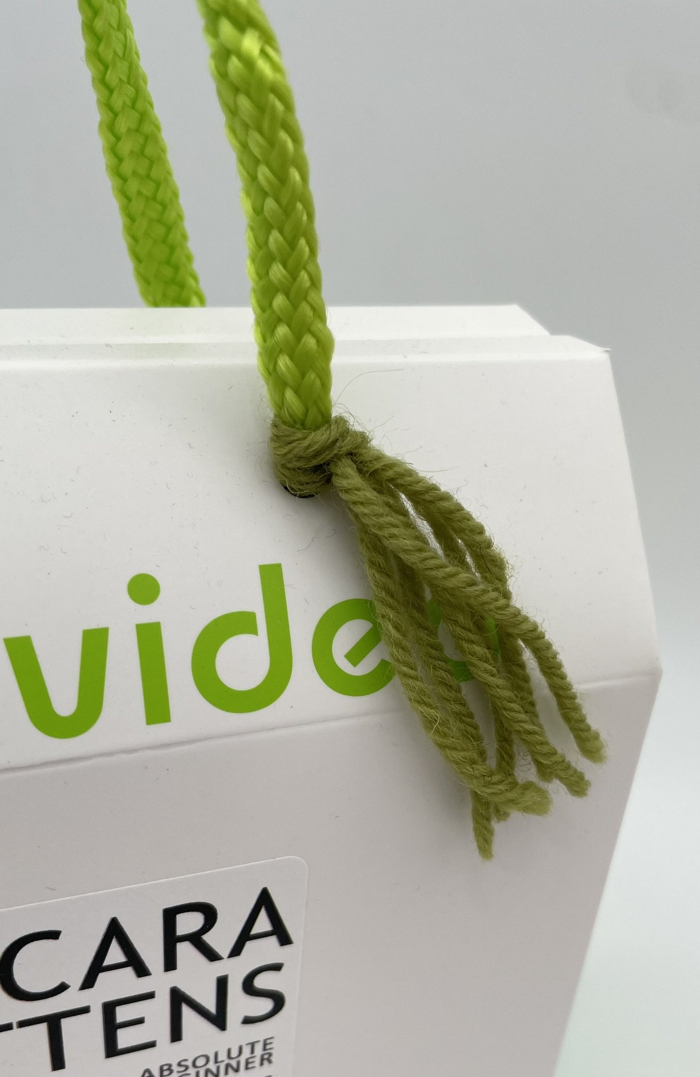 DIY Knitting Kit for Cara Mittens by Knitca with dark olive wool yarn and 5mm bamboo needles, suitable for beginner knitters.