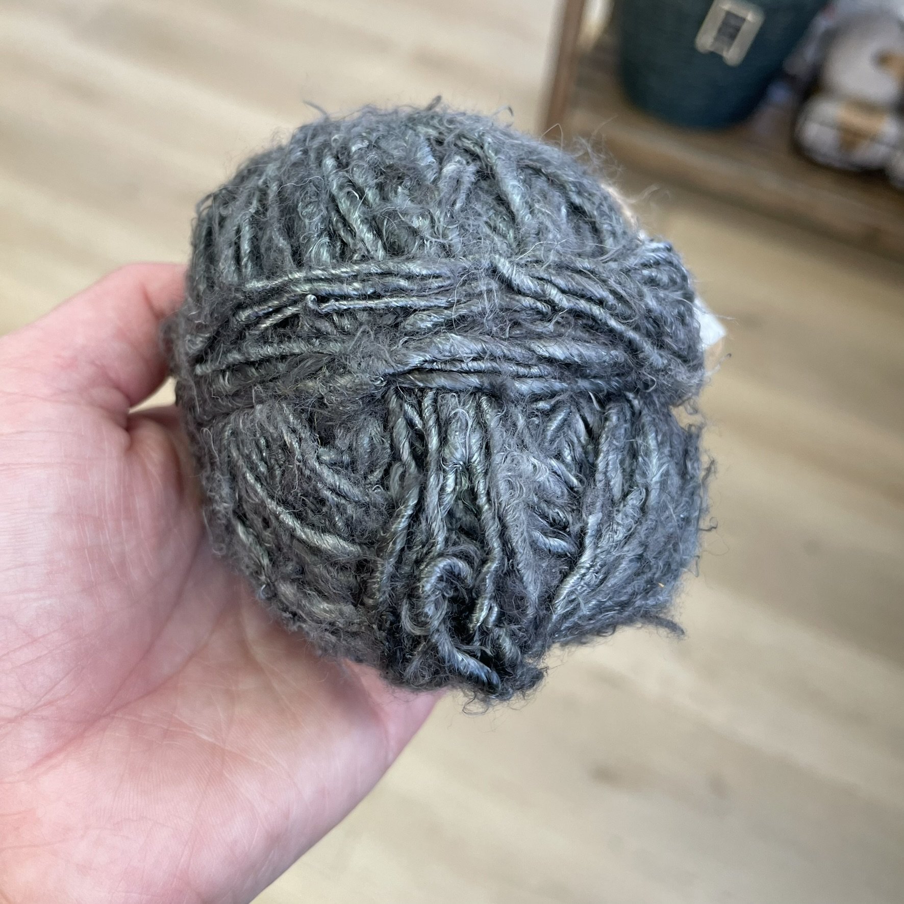 Steel Grey banana fiber yarn held in hand, showing the soft texture and eco-friendly material.