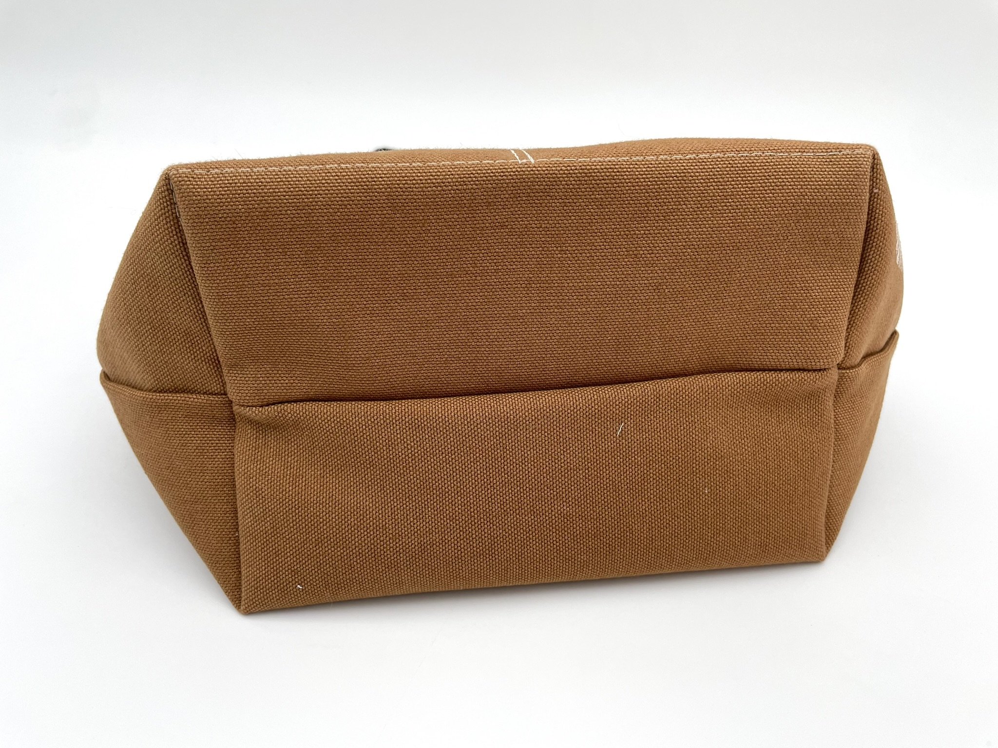 Bottom view of the small brown Puff Stitch project bag, showcasing its sturdy base.