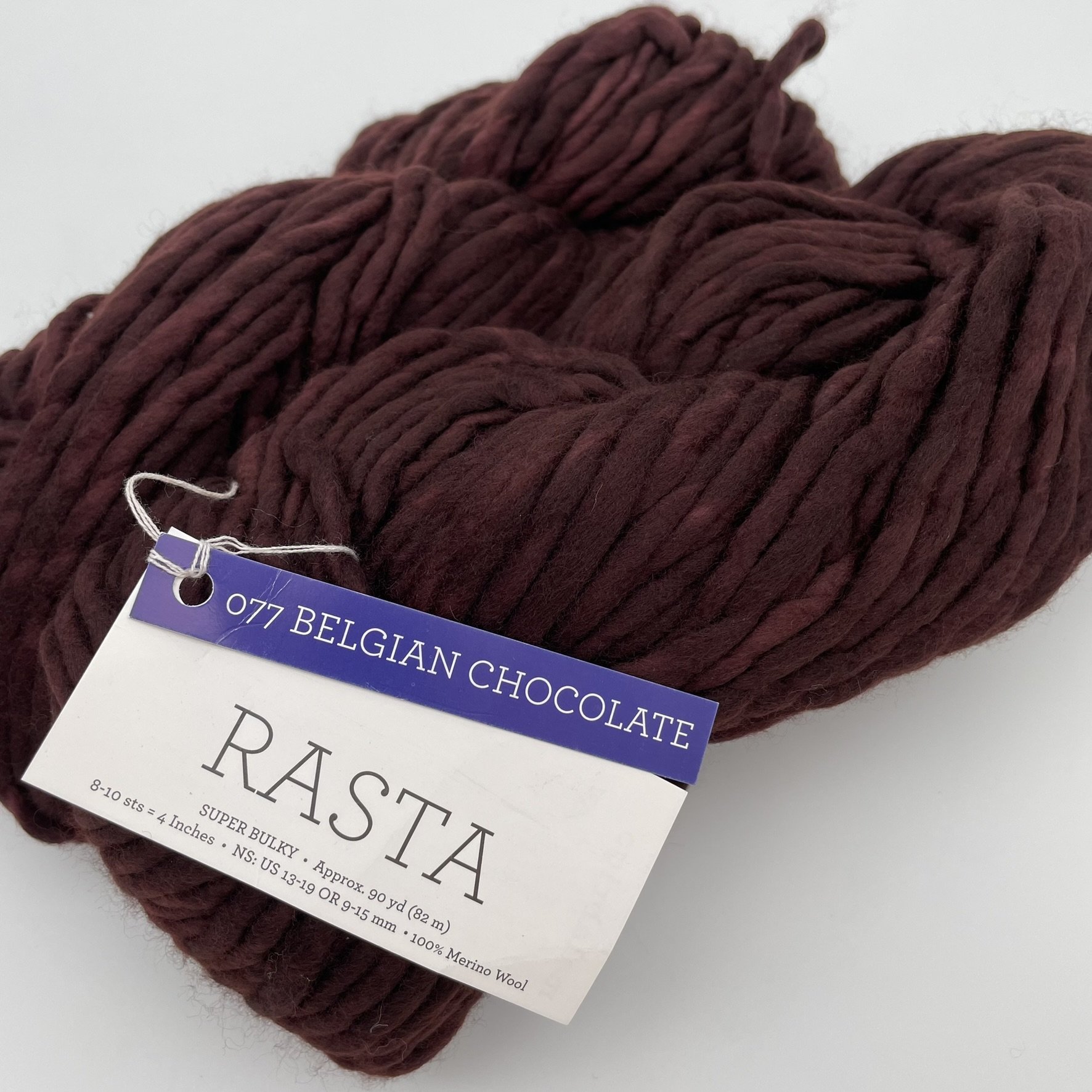 Close-up of Malabrigo Rasta yarn in Belgian Chocolate colorway, featuring deep brown tones in super bulky merino wool.