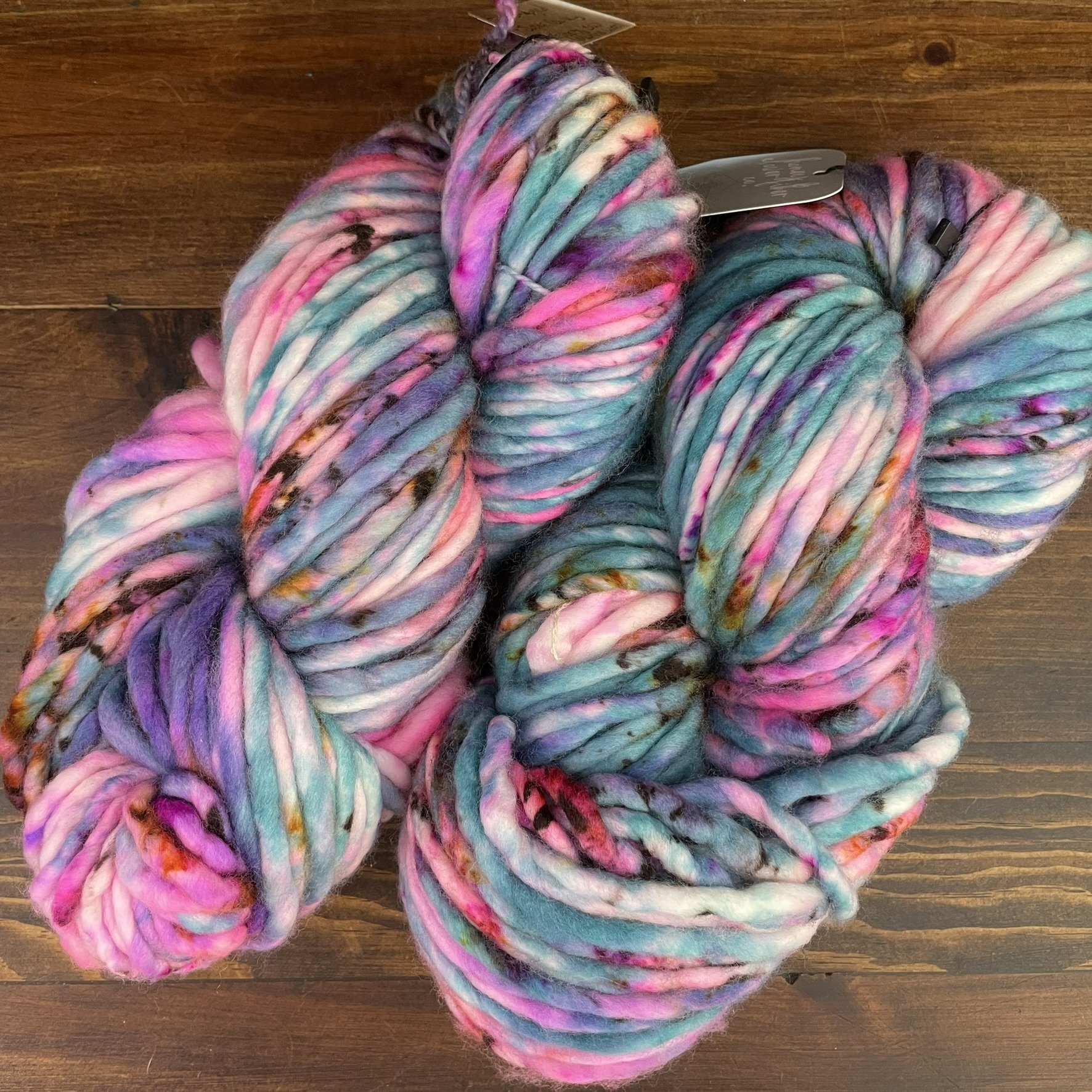 Honey & Clover Super Bulky Silent Lucidity yarn with delicate pastel tones including pink, white, and soft blue.