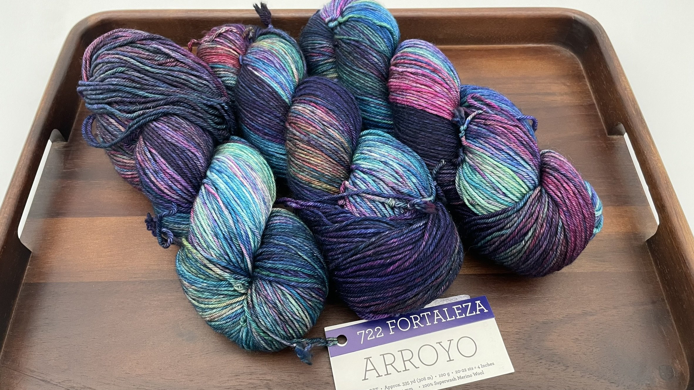 Front view of Malabrigo Arroyo Fortaleza color yarn in DK/Sport weight, beautifully displayed on a wooden tray.