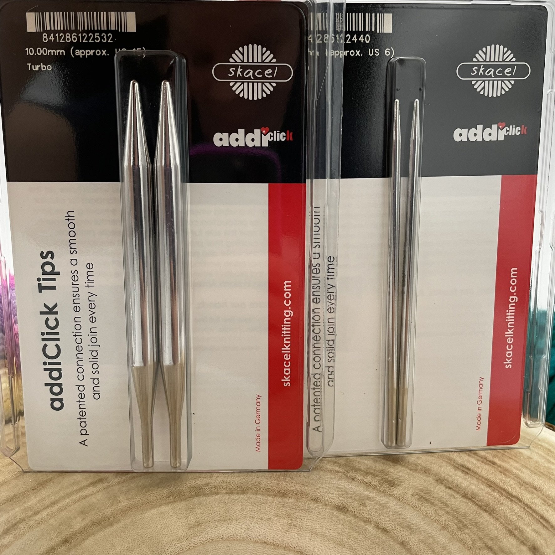 Multiple sizes of AddiClick Turbo knitting tips in packaging, featuring size US 6 and US 15.
