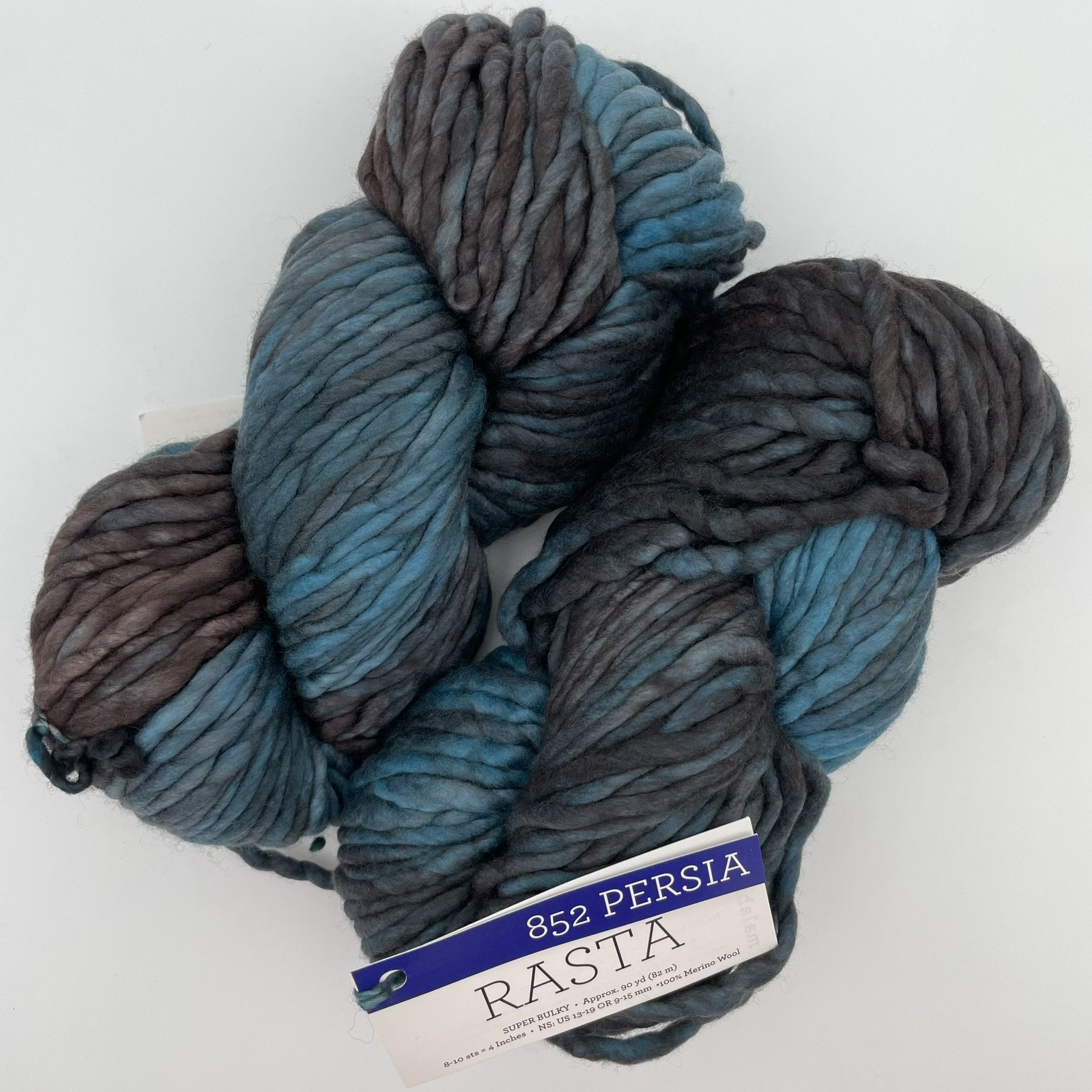 kein of Malabrigo Rasta yarn in Persia color, with a mix of deep blues and grays, super bulky, 100% Merino wool.