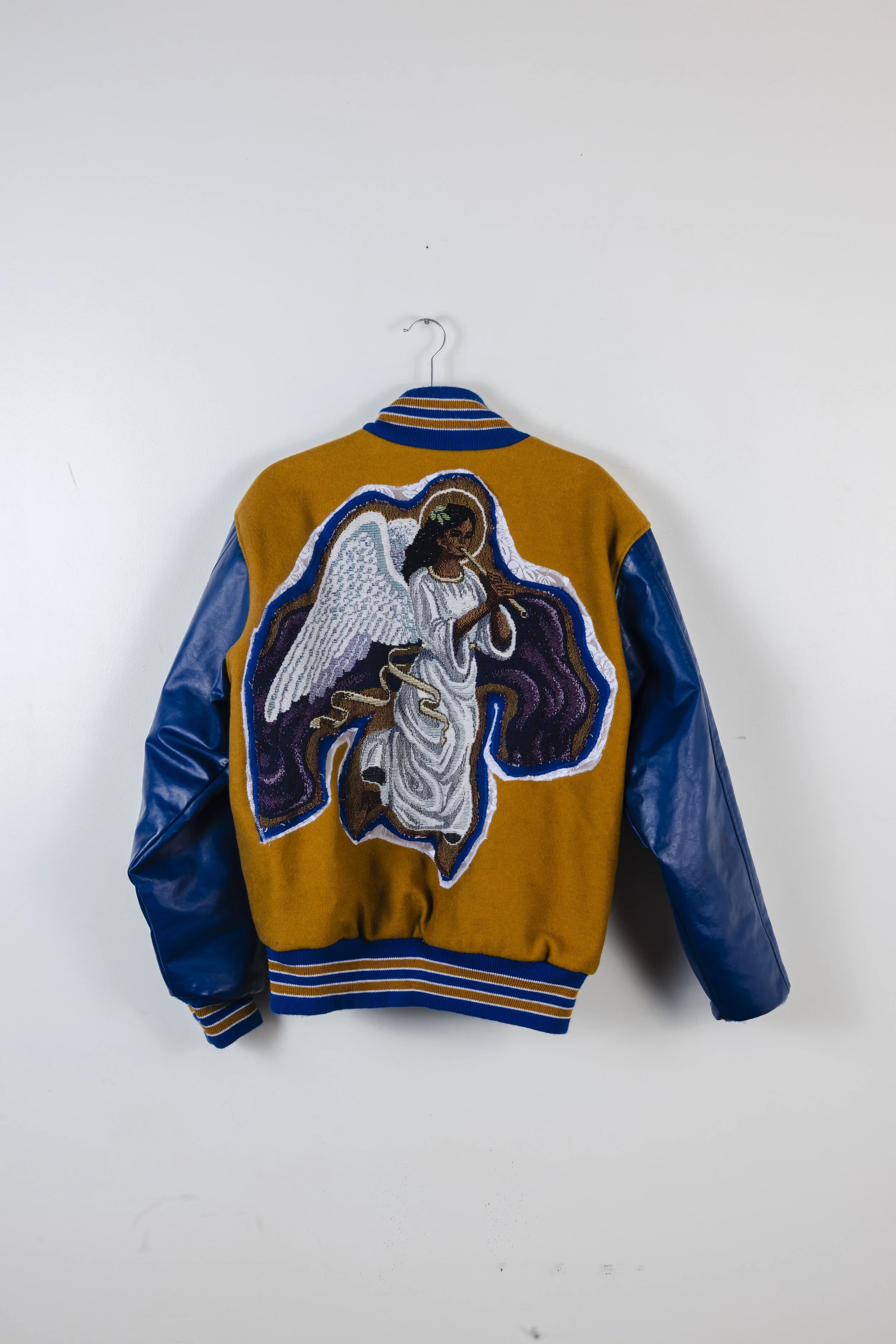 “Guardian Angel”
Created for the GRWM Runway Collection, this jacket serves as an ode to guardian angels who have transitioned, symbolizing their constant protection and presence surrounding us. Constructed from a vintage tapestry blanket, thrifted c