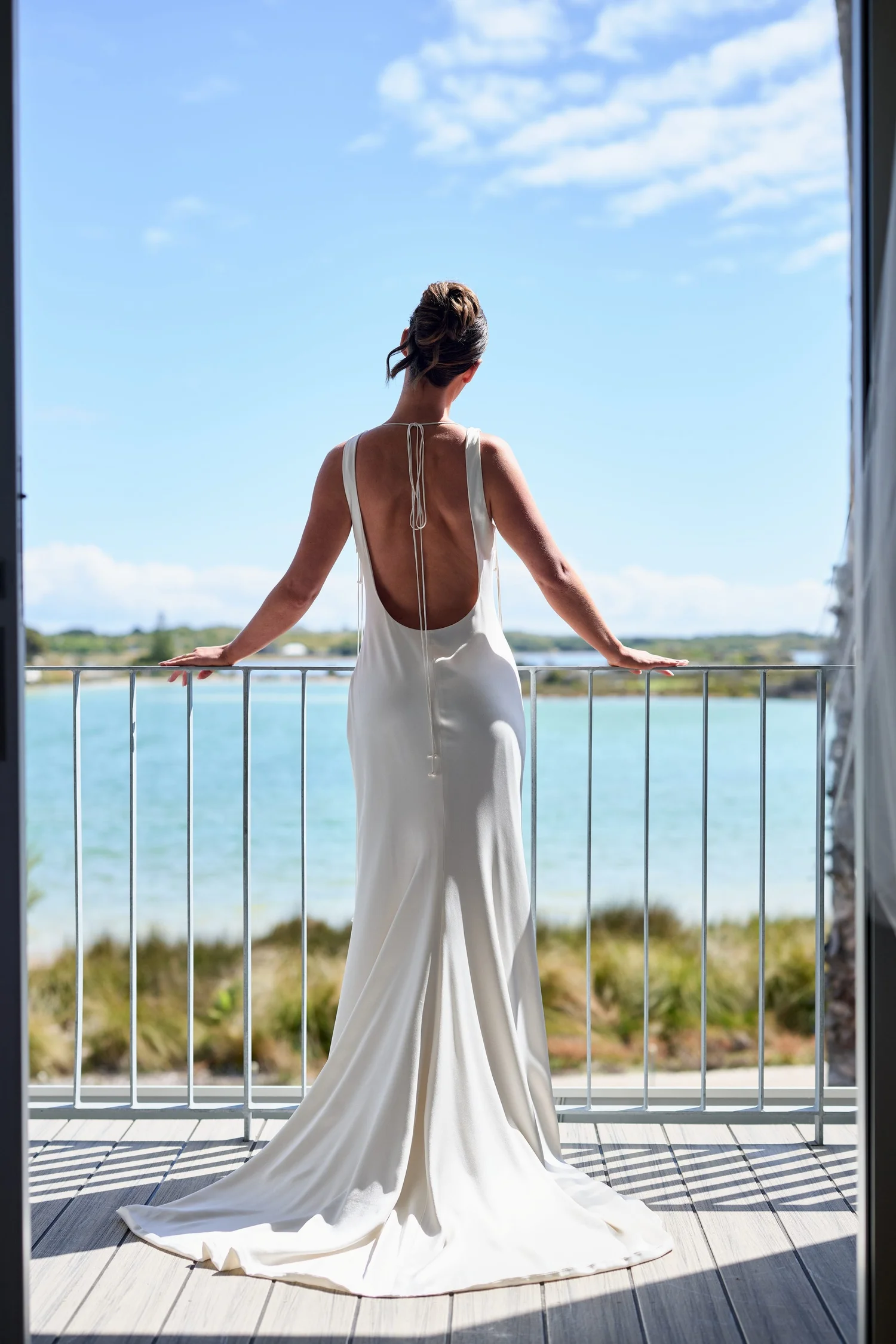 A bride on a balcony looking out over the salt lake