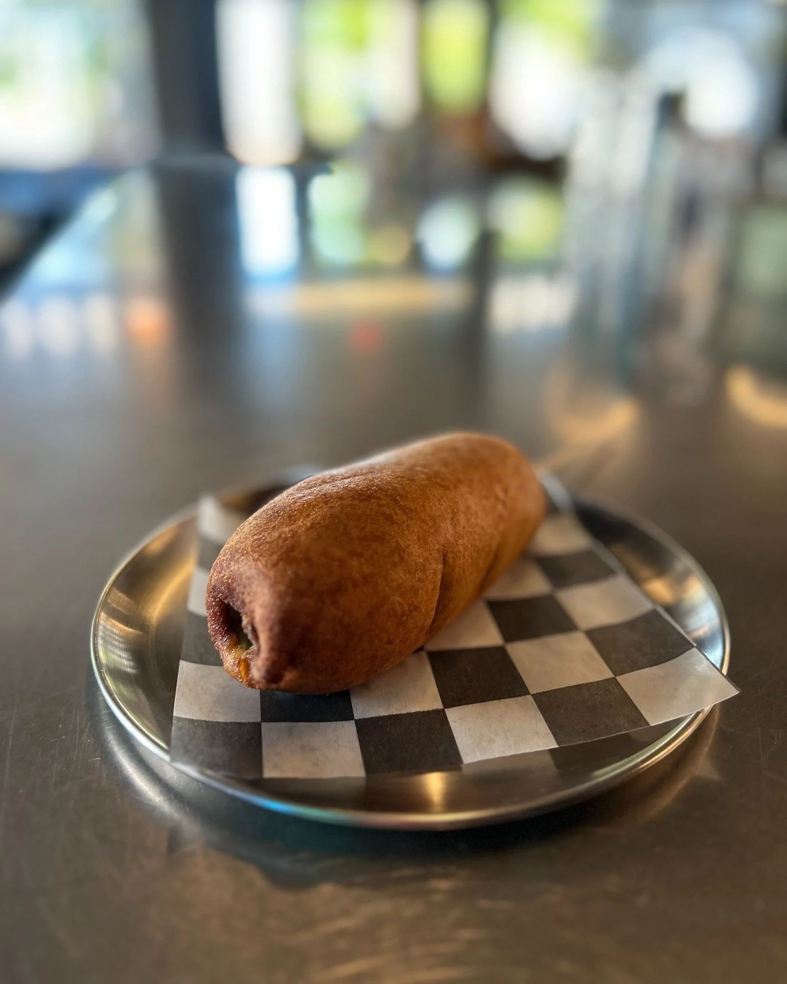 You might be thinking "Well that just looks like a normal corn dog"

You absolute fool! You couldn't be more wrong!

It's a corndog with a whole pickle inside it that has a hotdog inside it. Why would we do something like this? Because we c