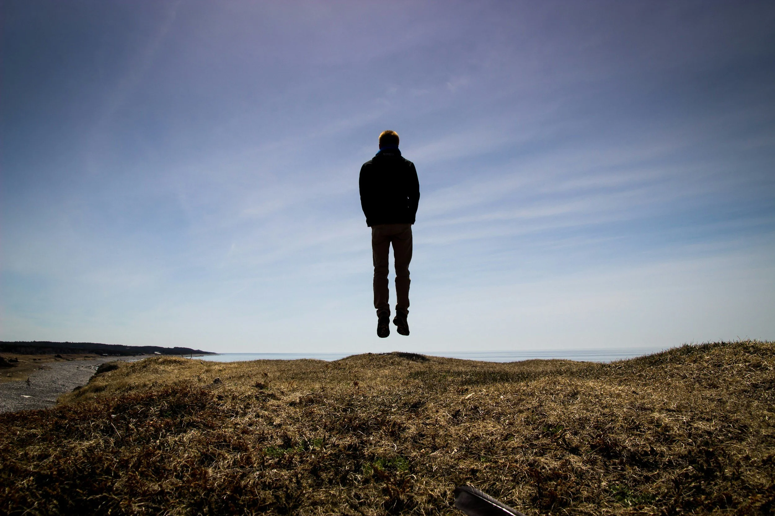 Man in a hoodie floating over the ground