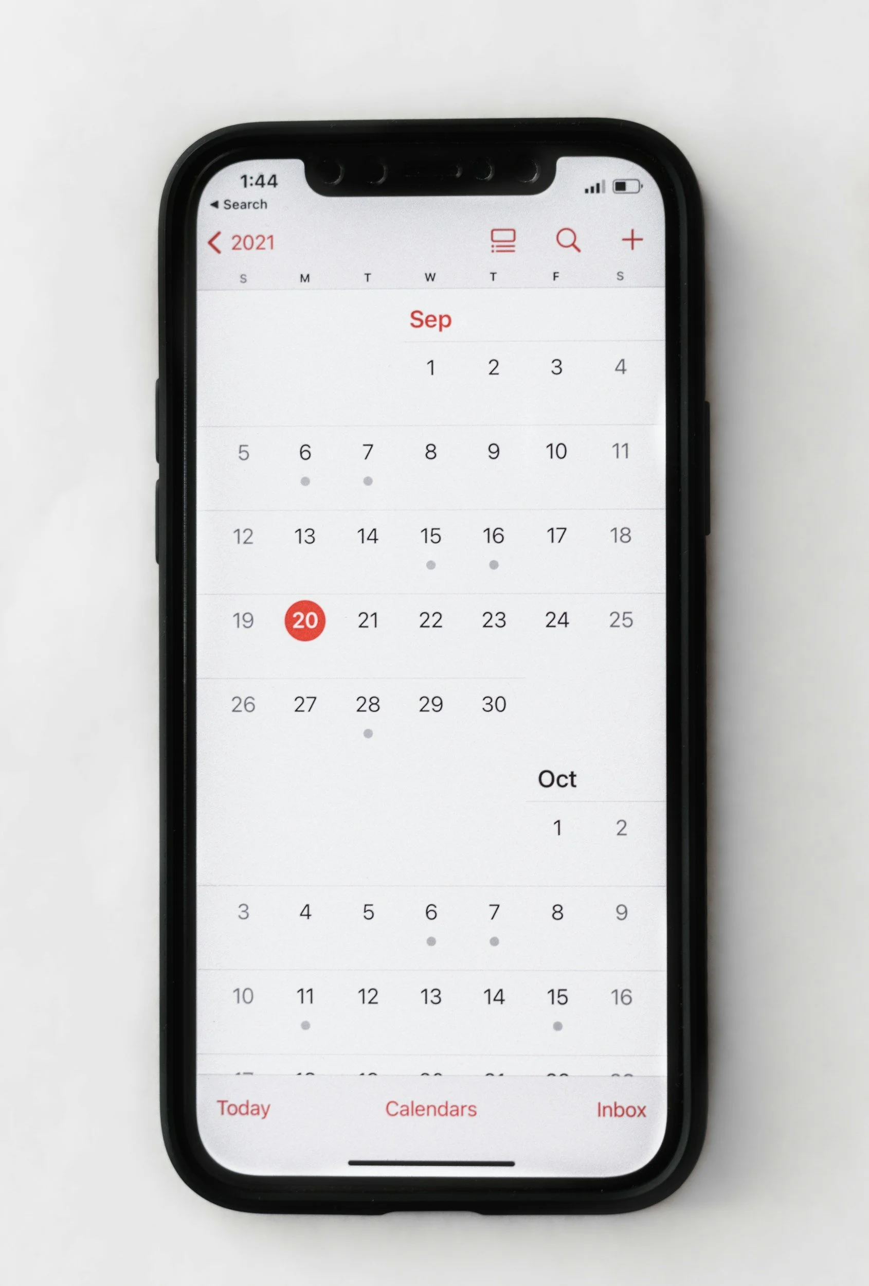 A smartphone displaying a calendar app with dates in September 2021, showing the 20th highlighted in red and the first few days of October.