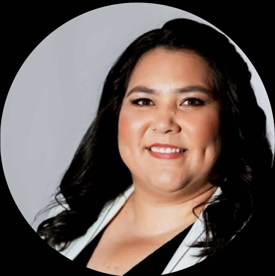 A single pink and white flower with a green center and stem against a light blue background.