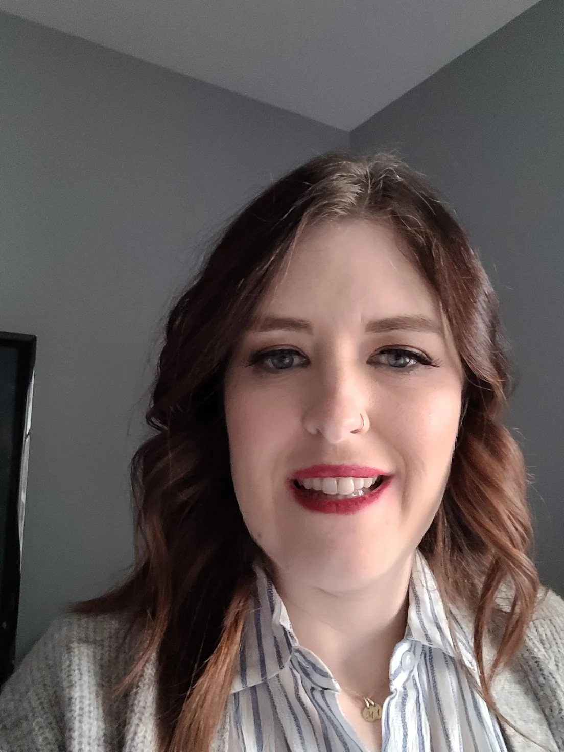 Close-up of a pink and white Gerbera daisy flower with a green stem, against a light blue background.