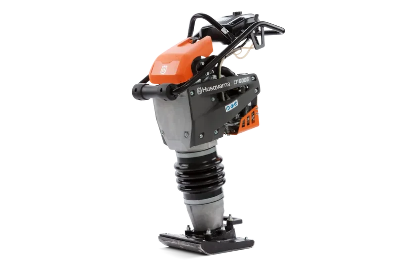 A Husqvarna moment rammer or compactor used for compacting soil or gravel, with a black and orange color scheme.