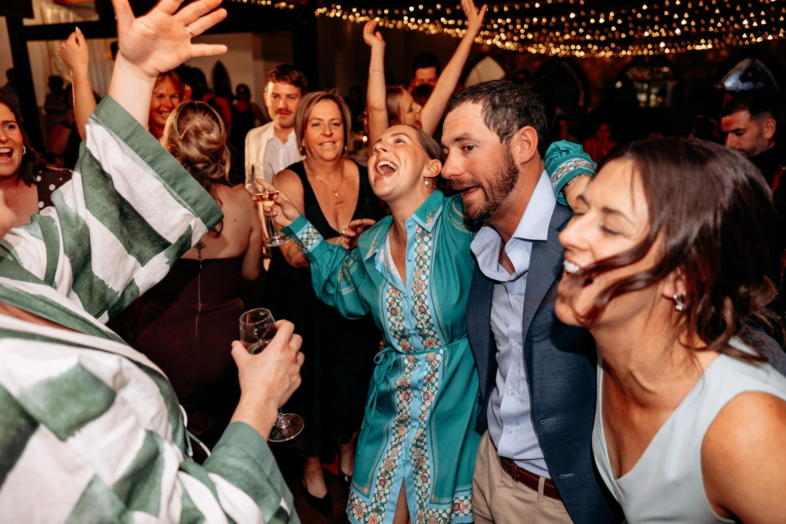 A group of friends dancing at a wedding