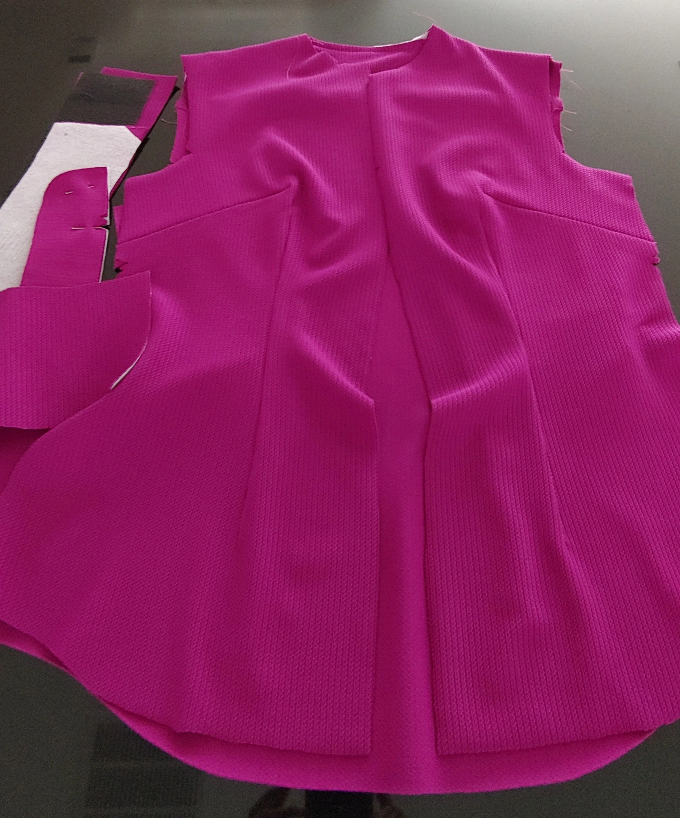 Work-in-Progress Jacquard Stretch Knit fabric pieces of the Fuchsia "Flirty" Fitted Long-Sleeve Shirt laid out on a dark surface.