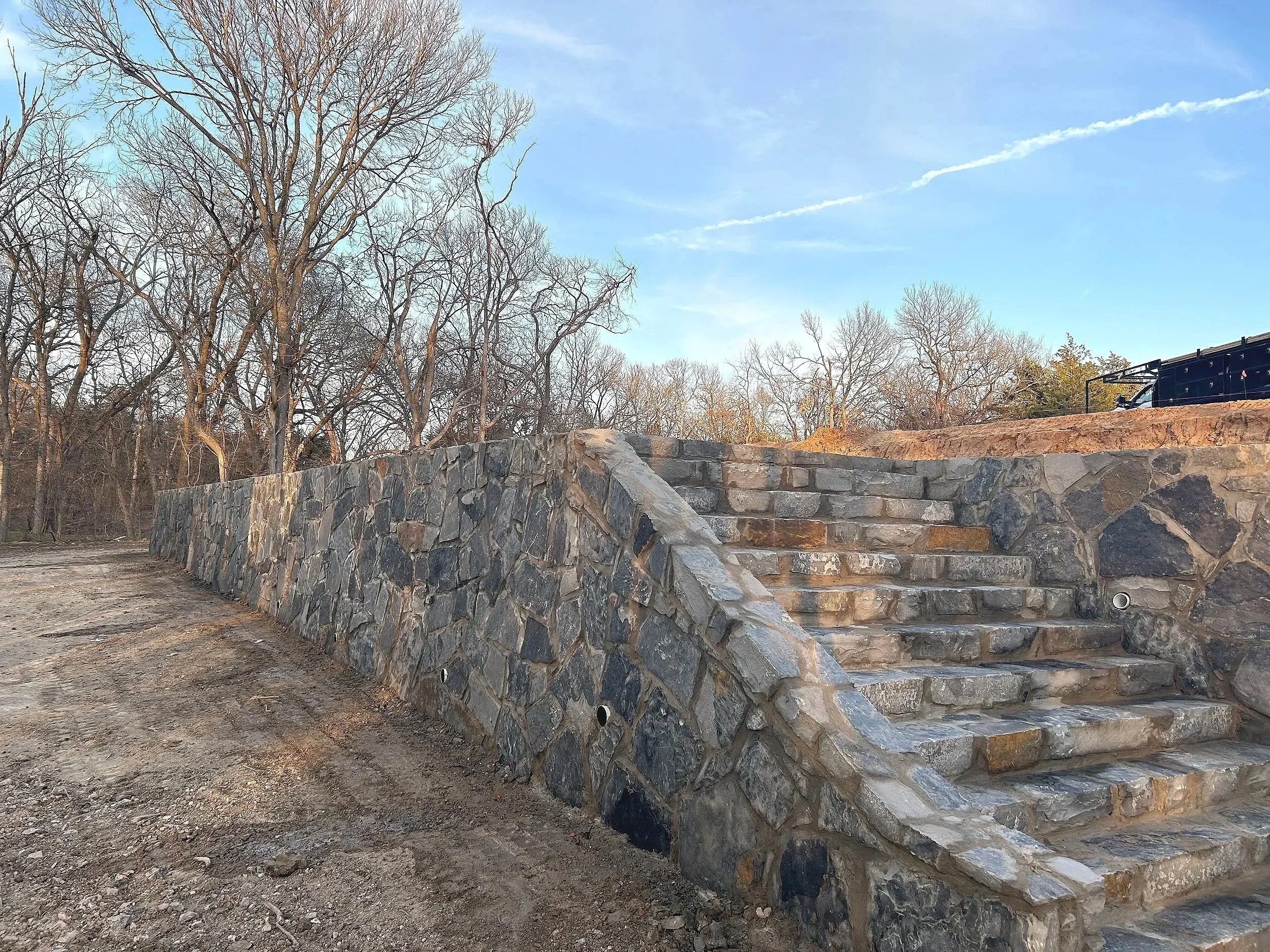 BLUE STONE RETAINING WALL AND STONE STAIRS.