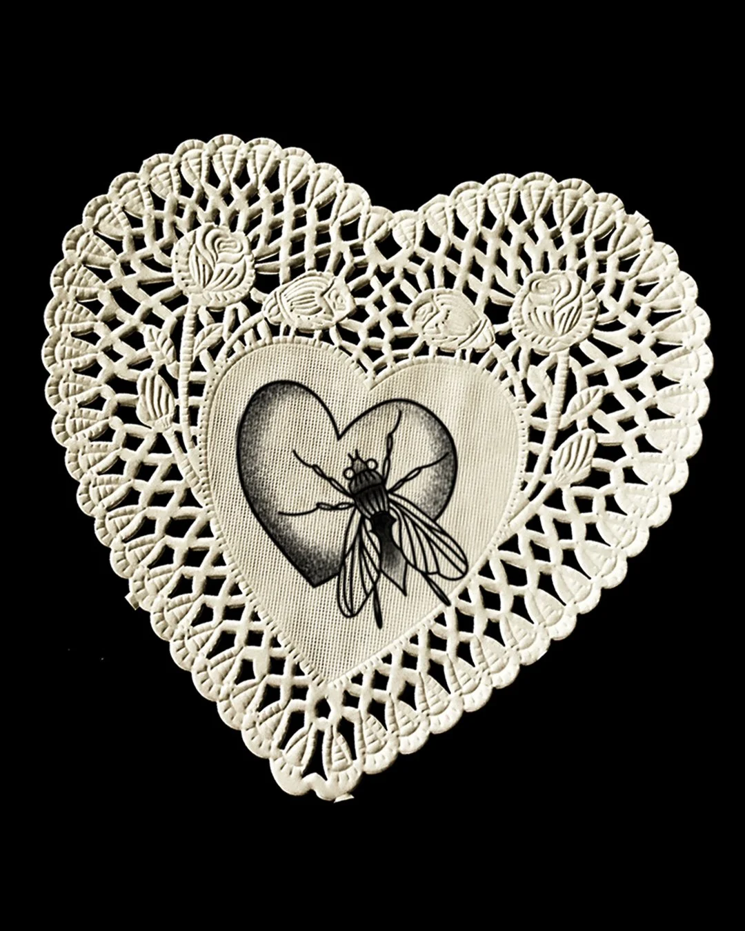 A decorative white lace heart with a detailed bee illustration inside a smaller heart at the center, against a black background.