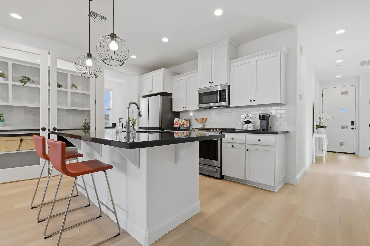 open modern white and black kitchen with kitchen stools in Lincoln California 