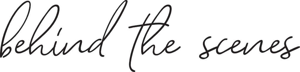 Black cursive text that says 'behind the scenes' on a transparent or pale background.