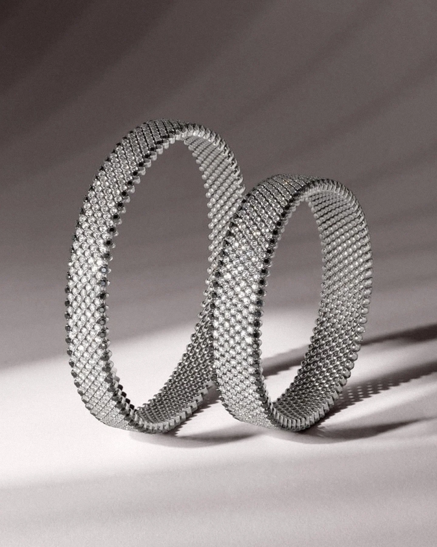 Where craftsmanship meets creativity. A distinctive jewel: a bracelet adorned with black and white diamonds, designed to be worn on the wrist or the arm.

#SerafinoConsoli #FineJewelry #Gold #Diamonds #rings