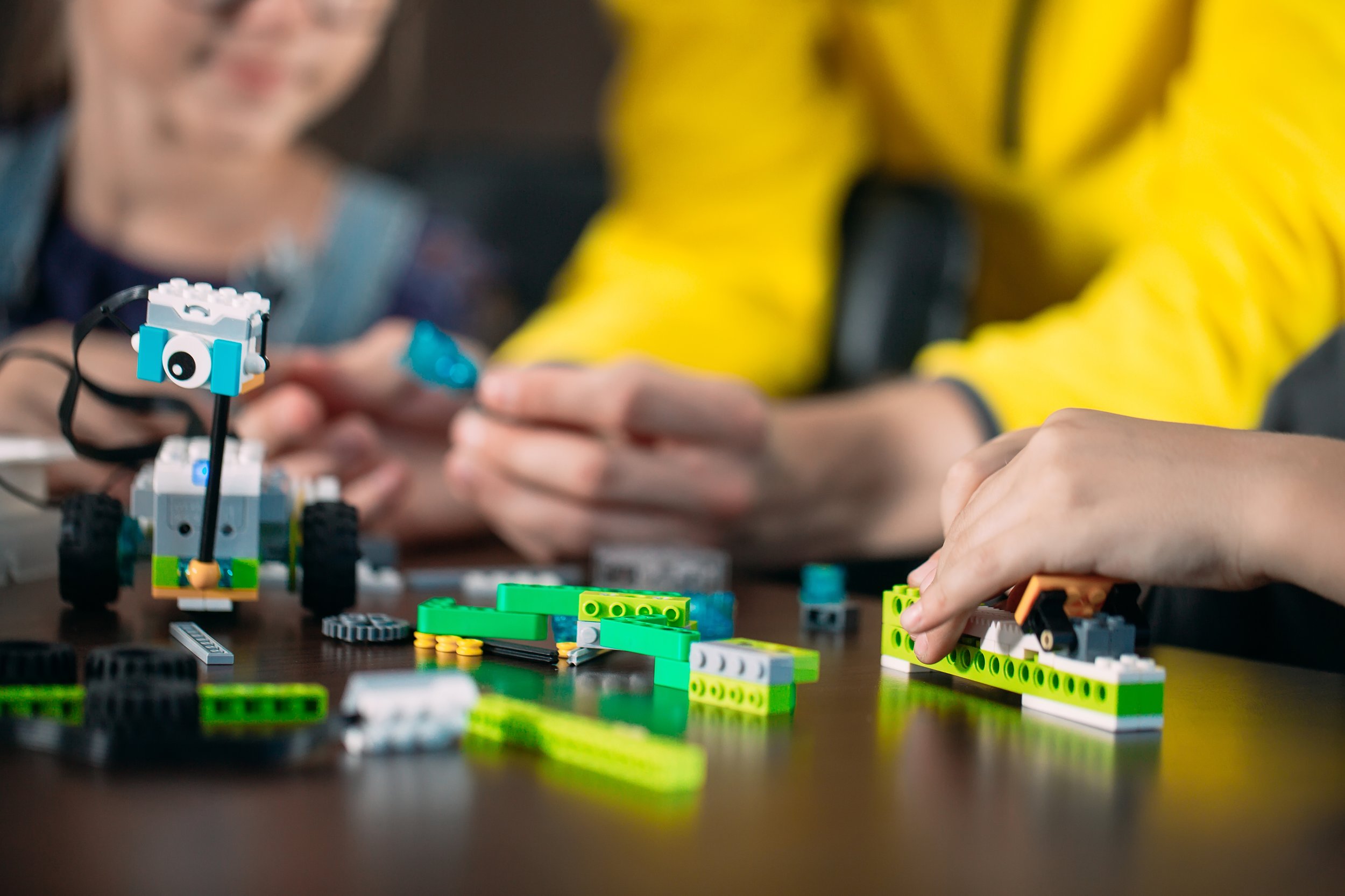 kids-creating-robots-with-teacher-early-development-diy-innovation-modern-technology.jpg