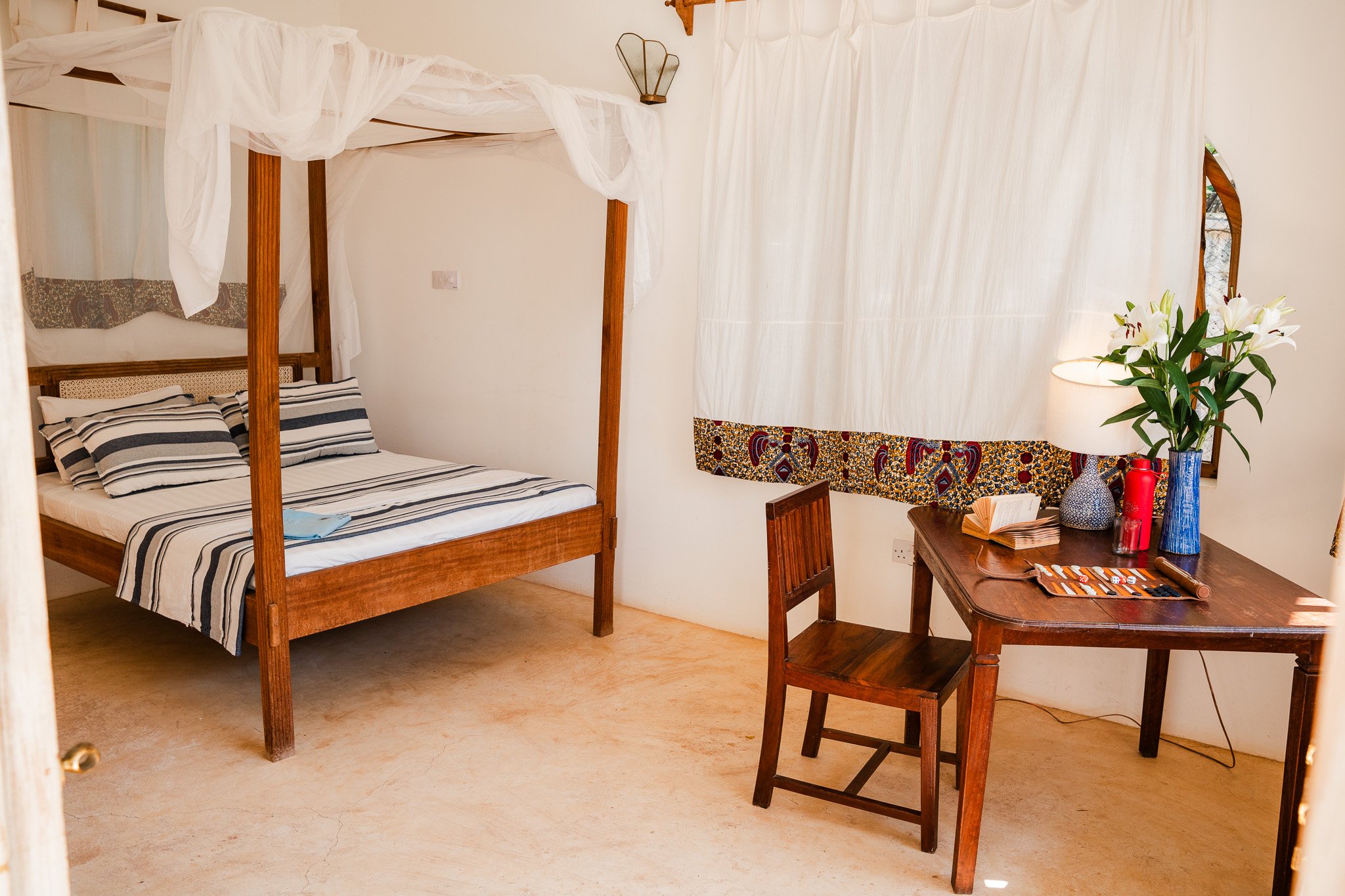Outside studio with a king-size bed, desk, and en-suite bathroom.