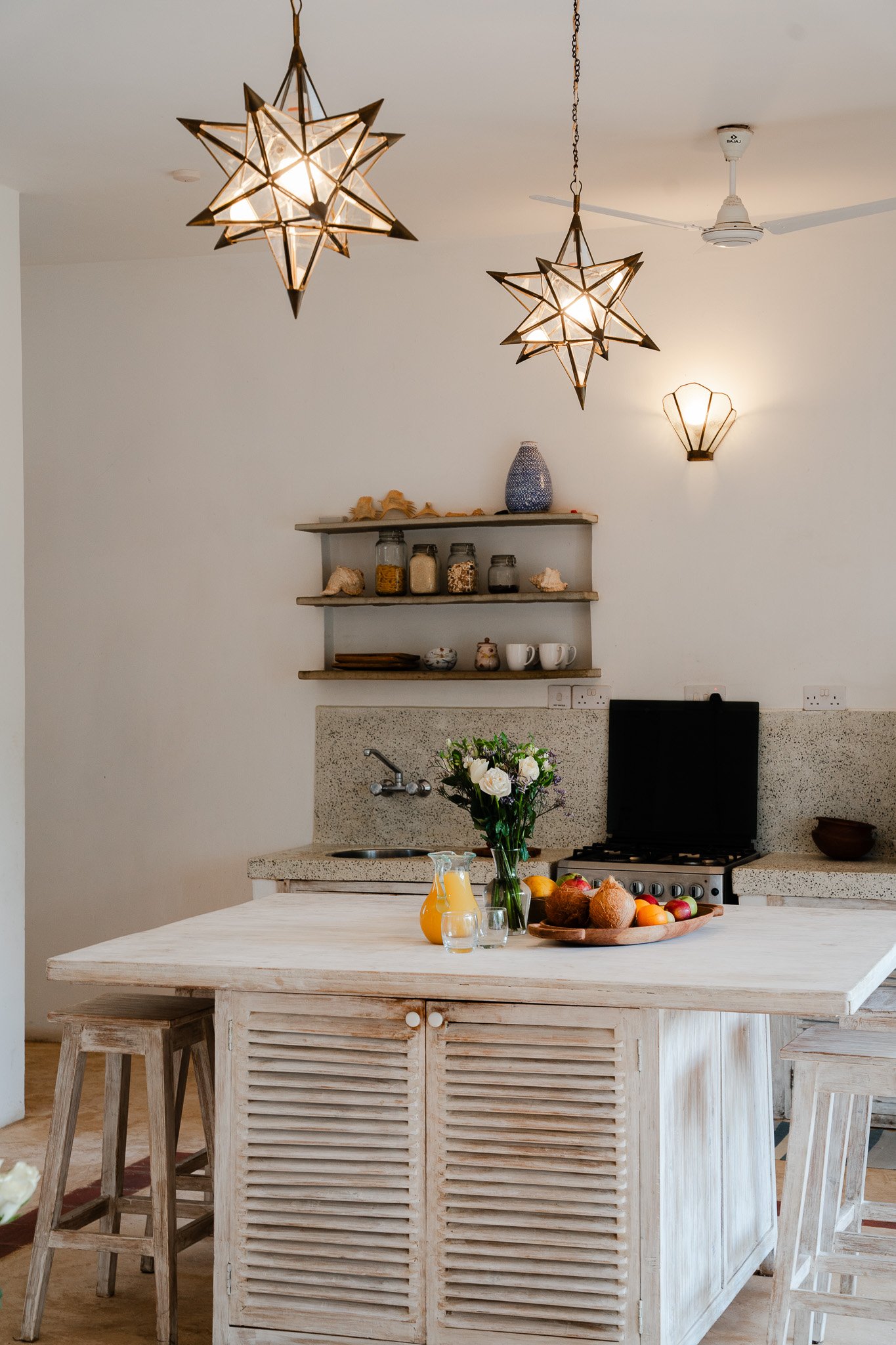 Kitchen features a kitchen island ideal for small kids.