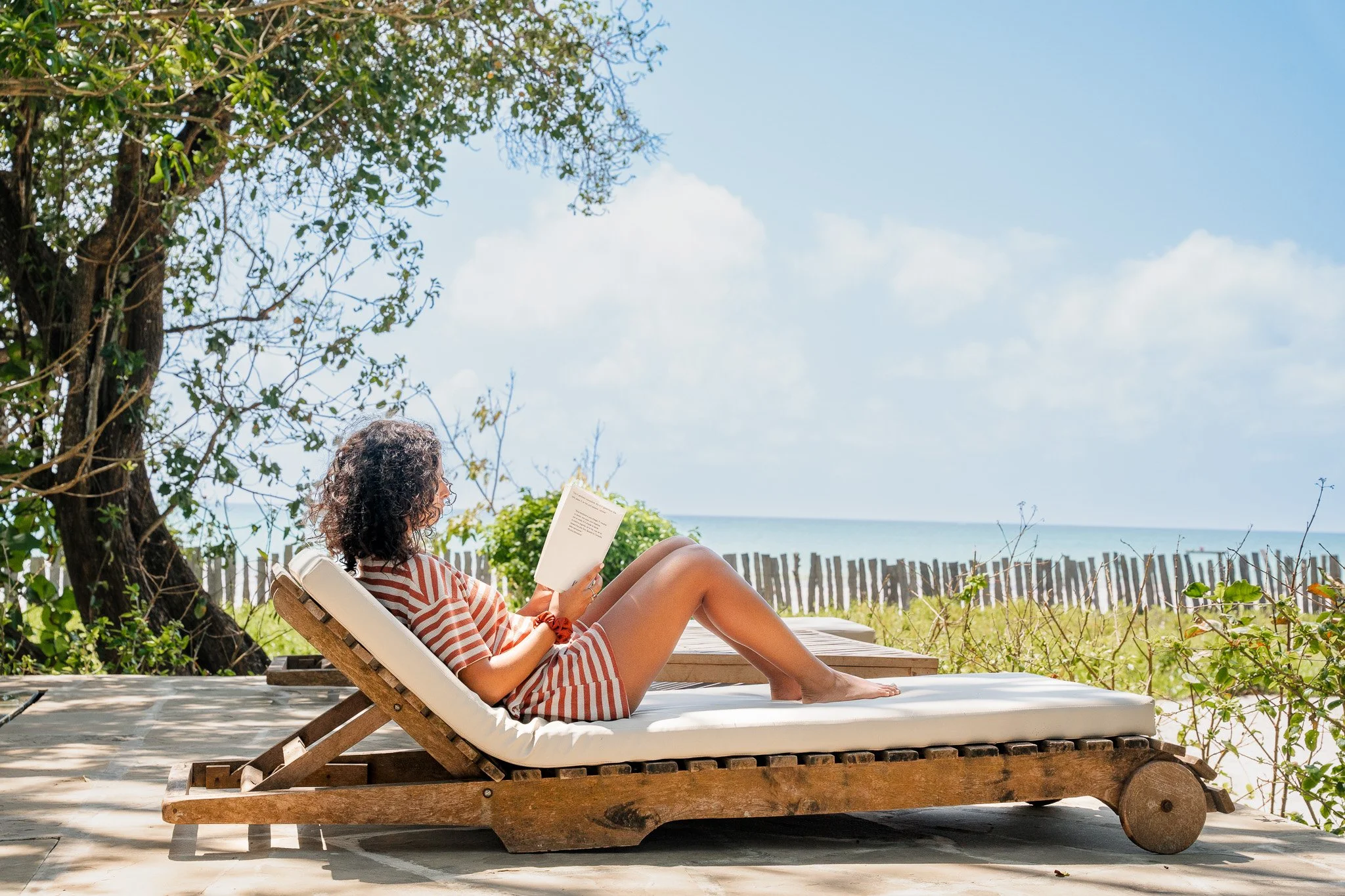 Enjoy a moment on the pool bed on the outside patio overlooking the beach.