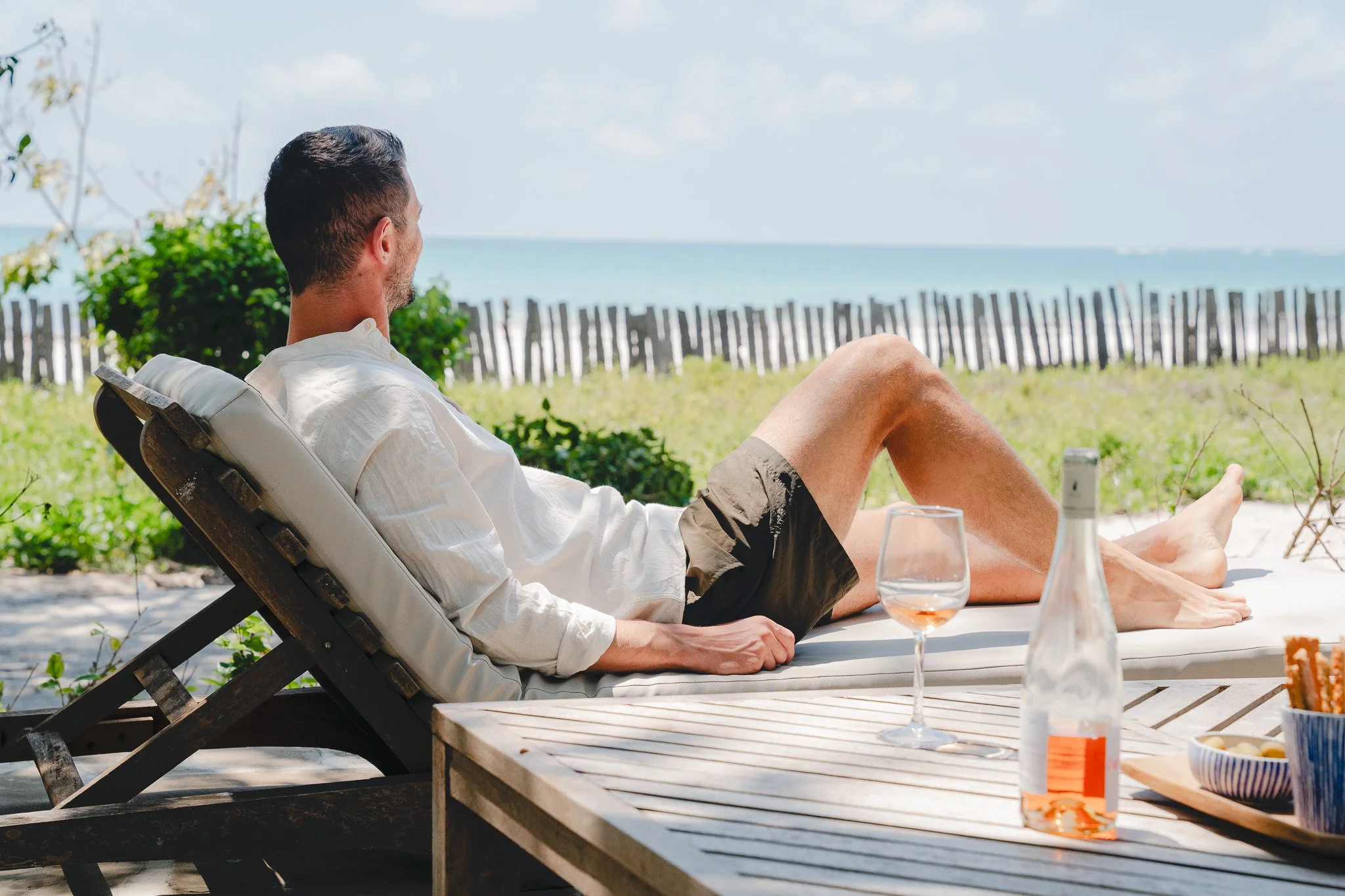 Enjoy a moment on the pool bed on the outside patio overlooking the beach.