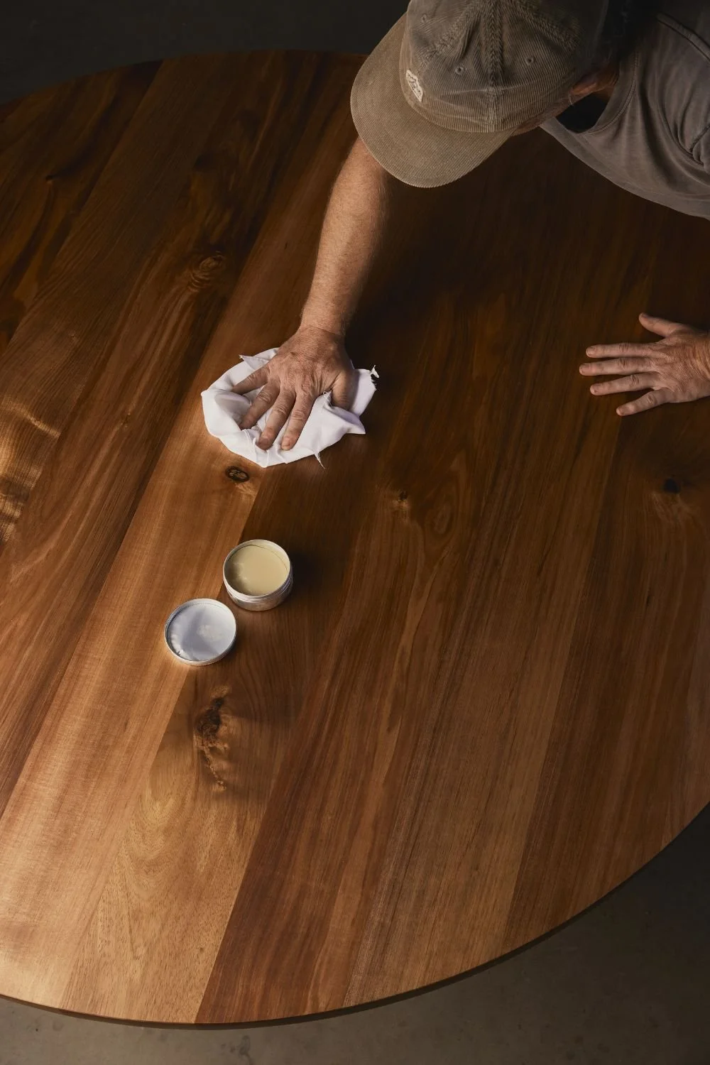 Tasmanian Blackwood round 8 seater dining table being oiled by hand by Anthony Christie. Using Osmo hard oil in Torquay, Victoria