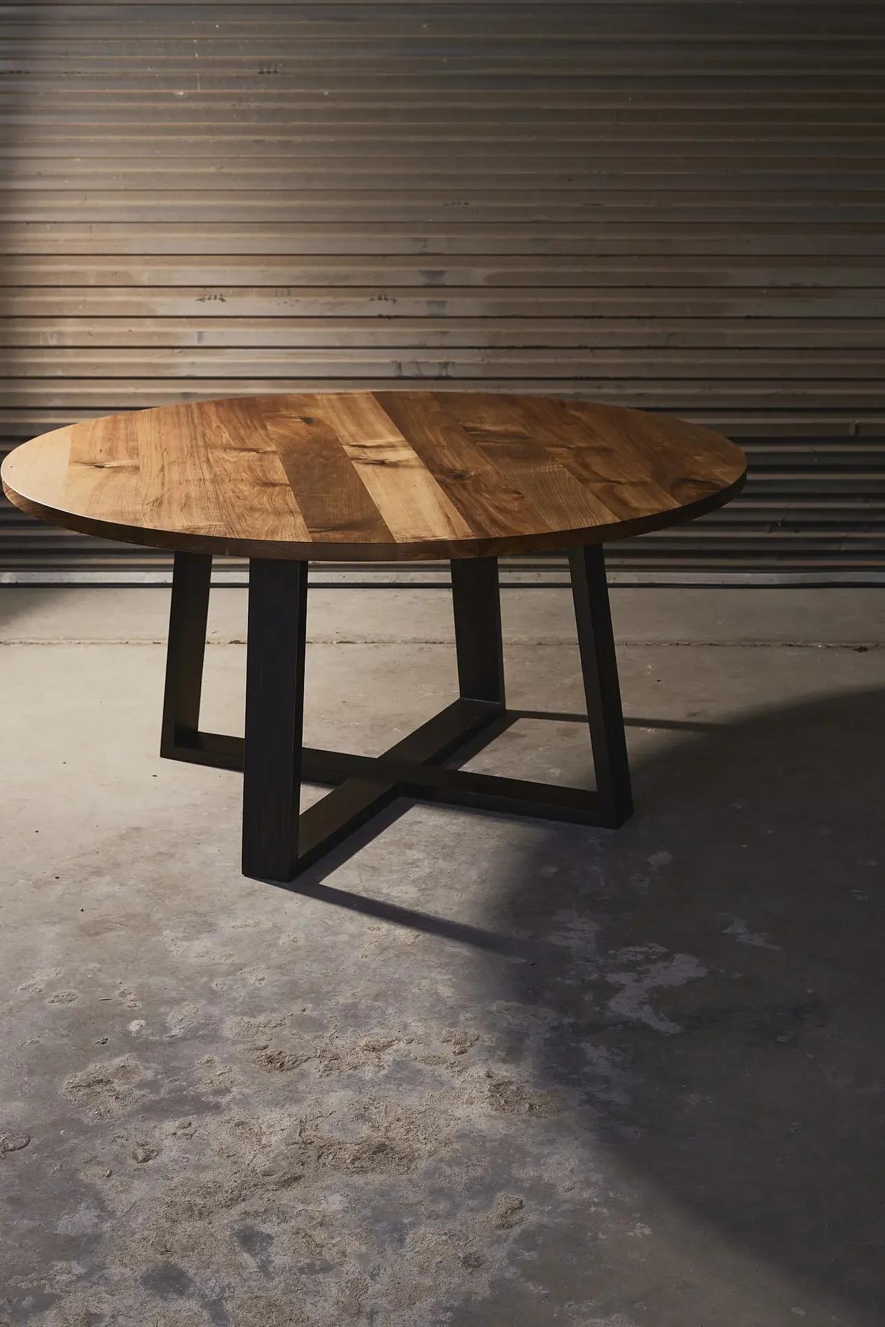 Large round dining table made from black wood and stained black legs. Seats up to 8 people