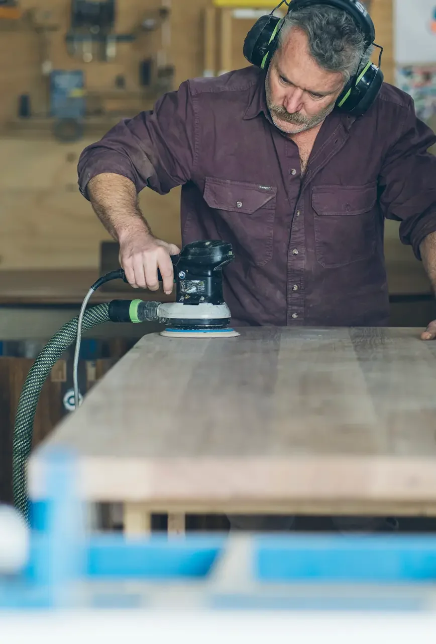 Anthony Christie using a hand plane in his workshop at Ashmore Arts in Torquay, Victoria